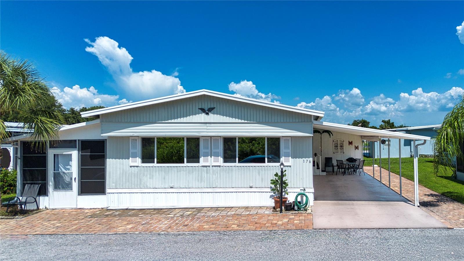 One or more photo(s) has been virtually staged. Charming Turnkey 3-Bedroom, 2-Bathroom Home in Skyway Village Estates, Affordable Living with Modern Updates & Convenient Location
Welcome to this move-in-ready manufactured home located in the sought-after, age-qualified community of Skyway Village Estates. With low HOA fees and a host of recent upgrades, this property offers the perfect combination of comfort, style, and convenience. Step inside this spacious 3-bedroom, 2-bathroom home, where you'll find a fully stocked kitchen and tastefully furnished interiors that include linens, tools, beach gear, chairs, grandchildren’s toys. The open floor plan is designed for easy living and entertaining, with a cozy yet spacious atmosphere throughout. Relax and unwind in the inviting Lanai, offering ample space for outdoor seating and gatherings. Minimal landscaping keeps maintenance a breeze, while interlocking pavers surround the front and side perimeter, providing room for golf cart parking, bicycles, a grill, and additional seating for all your outdoor needs. Recent updates to the home include a renovated guest bathroom, newer AC unit with ducting, a vapor barrier, and plumbing. The roof was replaced just 4 years ago, and energy-efficient windows have been installed, ensuring comfort and lower utility costs year-round. Skyway Village Estates offers a wealth of amenities, including a vibrant community atmosphere, recreational options, and easy access to everything you need. You’ll enjoy proximity to Gulf shore beaches, the Skyway Fishing Bridge, shopping centers, restaurants, medical facilities, and more. With convenient access to the interstate and nearby entertainment hubs, everything you need is just minutes away. Don’t miss the chance to own in a prime Florida location! Experience the lifestyle you deserve in Skyway Village Estates. Schedule your private tour today!