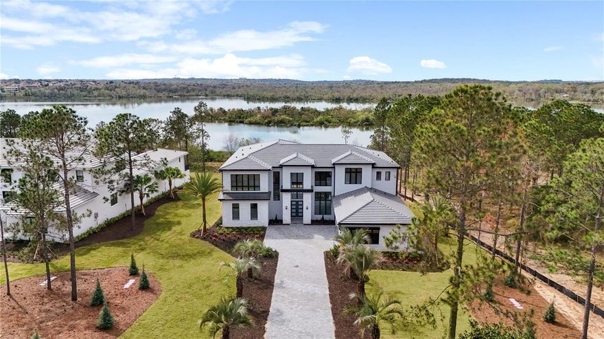 Embark on an unparalleled lakefront living experience in this exceptional Toll Brothers new construction home, all under the $3 million mark, nestled within the highly sought-after Bella Collina neighborhood. Discover the epitome of modern living in this exquisite 5-bed, 6.5-bath residence with a seamless open layout. Immerse yourself in the luxury of soaring ceilings and impeccable designer finishes that define sophistication in every room. Effortlessly balance work and leisure with a dedicated office space and a versatile media room, creating ideal settings for productivity and relaxation. The allure extends outdoors, where an expansive backyard awaits, perfectly primed for the addition of a luxurious pool – a potential oasis for ultimate leisure and entertainment. This property encapsulates the essence of contemporary luxury, offering a harmonious blend of thoughtful design and practical amenities. Set on over an acre of prime real estate, it stands as a testament to refinement and sophistication, providing direct access to the tranquil waters of Lake Apopka. Savor every moment surrounded by natural beauty, from the tranquil sounds of the lake to the stunning sunsets. Whether relaxing on the expansive patio or entertaining in the open-concept living spaces, delight in the seamless blend of indoor-outdoor living. With its elegant design, luxurious amenities, and breathtaking views, seize this once-in-a-lifetime opportunity to embrace the enchanting allure of lakefront living in Bella Collina. Schedule your private showing today and discover the epitome of luxury living on Lake Apopka. Some photos are virtually staged. Bedroom Closet Type: Walk-in Closet (Primary Bedroom).