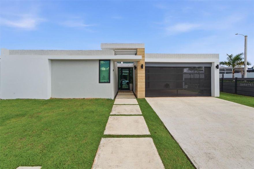 Step into the perfect blend of modern design, everyday comfort, and peace of mind with this recently built, single-level corner home on a 510 sq. meter lot, ideally positioned at one of the best streets in the desirable Residences at Río community. Enjoy quick access to top private schools while living with the security and lifestyle you want, including 24/7 gated security, a resort-style pool, fully equipped gym, and sports courts.
Designed for efficiency and resilience, the property features solar panels paired with two Tesla Powerwall batteries, delivering reliable backup power and added energy savings. Inside, you’ll find 1,960 sq. ft. of living area with a functional layout that flows beautifully: 4 bedrooms, 3.5 bathrooms, a spacious kitchen, open-concept living and dining areas, a dedicated laundry room, and excellent storage.
Move-in ready and well cared for, the sale includes brand-new appliances, window curtains, and more. A spacious storage area next to the garage provides room for all your essentials.
This is a rare opportunity to own a modern, secure, energy-smart home in one of Bayamón’s most sought-after neighborhoods. Contact us today to schedule your private showing.