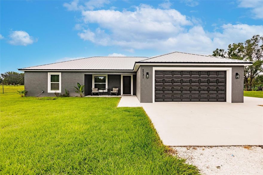 Step into your own contemporary farmhouse oasis! This stunning residence boasts a spacious and cozy three-bedroom, two-bathroom home, meticulously crafted with solid concrete block construction and a durable metal roof. Built in 2022, this home seamlessly blends modern design with rustic allure.

Approaching the property, you'll be captivated by the elegant dark exterior paint, exuding sophistication while harmonizing with the serene rural setting. The two-car garage offers ample parking and storage, complemented by an expansive concrete parking pad for extra vehicles or recreational equipment. Nestled on an expansive five-acre lot, this property is designated for animal use, making it an ideal haven for animal enthusiasts or aspiring agricultural entrepreneurs. The garden space is perfect for nurturing your favorite plants and relishing the pleasures of gardening. Step inside and discover the heart of this home—a mesmerizing kitchen featuring an island for culinary pursuits and gatherings. The walk-in pantry provides generous storage for your kitchen essentials, while the granite countertops offer a sleek and sophisticated workspace. This home offers an abundance of storage options, including generously sized closets throughout. The primary bedroom and one of the guest bedrooms include walk-in closets for ample storage. The primary bathroom is a sanctuary with its modern free-standing tub and a cutting-edge anti-fog touch-sensitive mirror, providing a tranquil escape for relaxation. The living room, dining room, and kitchen feature soaring ceilings that infuse the space with natural light and an open, airy ambiance. Luxury vinyl plank flooring adds an element of sophistication while ensuring durability and easy maintenance. Embrace the idyllic setting of this contemporary farmhouse as you relax on the back patio, overlooking the picturesque landscaped grounds that include a stocked pond, inviting you to indulge in leisurely fishing or simply savor the tranquil atmosphere. Located in a peaceful country setting, this property offers the serenity of rural living while remaining conveniently close to modern amenities. Seize the opportunity to make this contemporary farmhouse your own and embrace a lifestyle that combines comfort, style, and the beauty of nature.