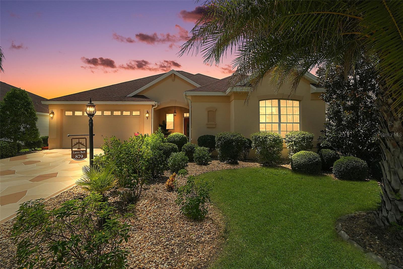 MAGNIFICENT 3/2 Camden TURNKEY with ENCLOSED UNDER-AIR LANAI and extended REAR DECK with LUSH TROPICAL LANDSCAPING and PRIVACY FENCING located in the heart of The Villages between Brownwood Paddock and Lake Sumter Landing Squares in the highly desirable Village of Hemingway! HVAC(2022) DECORATIVELY PAINTED DRIVE and WALKWAYS, QUAINT FRONT PORCH, and an ELEGANT LEADED GLASS door with retractable screen and transom welcome you in to the generous foyer of this METICULOUSLY-MAINTAINED home featuring NEW and CUSTOM drapes throughout! The OPEN CONCEPT living, dining, and kitchen showcase 10’ HIGH CEILINGS adorned with CROWN MOLDING creating a SPACIOUS and voluminous main living area. Rich, warm-toned LAMINATE floors grace the living and dining rooms along with a plethora of windows for an ABUNDANCE of natural light. The AMAZING kitchen boasts WHITE cabinetry with pull-outs, GRANITE countertops, GLASS-TILED backsplash, under cabinet lighting, STAINLESS appliances, built-in PANTRY, EAT-IN breakfast bar, and TILE floors. From the main living area, 8’ high sliding glass doors with a CUSTOM CORNICE lead you into the FABULOUS UNDER-AIR ENCLOSED LANAI featuring DIAGONAL TILE flooring, 10’ HIGH ceilings, and SURROUNDING SLIDING WINDOWS. An exterior FRENCH door opens to the EXTENDED REAR DECK. This INCREDIBLE OUTDOOR SPACE boasts PVC decking, gorgeous PALMS, and PRIVACY FENCING creating a TRANQUIL TROPICAL HAVEN- perfect for entertaining friends and family or simply enjoying the beautiful Florida weather! Back inside this wonderful home, the luxurious primary bedroom boasts 10’ HIGH ceilings, a LARGE WALK-IN closet, and BRAND NEW plush carpeting (8/2025). Its en-suite bathroom features TILE flooring, WHITE cabinetry, GRANITE counters, DOUBLE vanities, TILED WALK-IN ROMAN shower, LINEN closet, and a separate water closet. Two additional bedrooms and second bathroom are conveniently located near the front of the home, creating a PRIVATE GUEST WING and/or QUIET home office. Bedrooms two and three each feature 10’HIGH ceilings and BRAND NEW plush carpeting. The third bedroom boasts a CUSTOMIZED closet and the second a built-in closet. The second bathroom offers TILED floors, WHITE vanity with GRANITE countertop and VESSEL sink, TILED tub and shower combination, and a hallway LINEN closet. A centrally located INTERIOR laundry room features TILE floors and shelving. Completing the package is a 480sf two-car garage offering built-in storage cabinetry, overhead storage rack, utility sink, and pull-down stairs with attic access. DON'T MISS THE OPPORTUNITY TO MAKE THIS MAGNIFICENT HOME YOUR OWN! The Village of Hemingway is nestled in the heart of the Villages between Brownwood Paddock and Lake Sumter Landing Squares; Havana and Bonifay Golf and Country Clubs; Sarasota Golf Academy Practice Center; Truman, Seabreeze, and Colony Cottage Recreation Centers; Hemingway Pool along with multiple pools and pickle ball courts; and 466A with an abundance of shopping, restaurants, banks, and medical. PLEASE WATCH OUR WALKTHROUGH VIDEO OF THIS STUNNING HOME and call today to schedule your Private Showing or Virtual Tour!