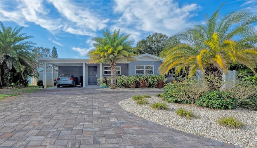 Paradise Found! This turn-key C-block construction home is an entertainer’s dream, seamlessly blending indoor luxury with a private tropical oasis. Discover an open, bright, and airy floor plan designed for modern living. Step outside to a lushly landscaped sanctuary where extensive pavers lead to a stunning screen-enclosed pool area, complete with ambient recessed track lighting and a dedicated Tiki Hut—perfect for resort-style relaxation or hosting unforgettable gatherings. The home is truly move-in ready, featuring recent high-value updates including a new roof, windows, and sliding doors. Added conveniences like indoor laundry with ample storage enhance daily living. All this peace of mind comes with the unbeatable bonus of being located in a desirable NON-FLOOD ZONE.