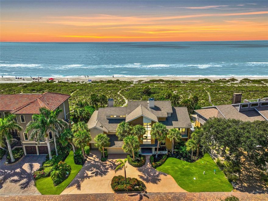 HURRICANE UPDATE - WATER NEVER REACHED THE HOME (INSIDE) - New and Improved Price! Welcome to your exclusive Gulf of Mexico beach house retreat on Siesta Key, where luxury seamlessly merges with the allure of Turtle Beach in Tortoise Estates. Located on the Gulf, this 4-bedroom luxury residence epitomizes coastal living, offering private beach access and spectacular, panoramic views of the Gulf of Mexico stretching from Lido Key to the Venice Inlet. As you step inside, an elevator or staircase leads you to the main floor, where cathedral ceilings welcome you to a world of opulence. The formal, but open concept, living and dining rooms feature a wall of sliding glass doors that open to the screened porch offering panoramic views of the pristine beach and exterior landscapes. The heart of the home lies in its open concept living space, featuring a kitchen, family room, and casual dining area. Enjoy morning coffee on the deck and daily meals with ocean vistas, conveniently prepared in the well-appointed kitchen, complete with an electric cooktop and breakfast bar. The family room is brightened by cathedral ceiling windows, anchored by an incredible, two-story stone fireplace that creates a cozy, serene space that is connected to the screen porch by a wall of expansive sliding doors and breathtaking beach views. The main level hosts the private primary suite, a sanctuary with high ceilings, abundant natural light, and an ensuite bathroom featuring a soaking tub, shower, vanity with extensive space and two walk-in closets. The bedroom has beach views and sliding doors that open to the covered porch, which has floor to ceiling screens and runs the full 80’ length of the home connecting it with the family room, kitchen, dining and living rooms. The porch ties the entire main floor together and provides a weather protected perch to enjoy spectacular Gulf views and mesmerizing sunsets. A private office with a wall of built-in drawers and glass cabinets is the perfect venue for remote working and completes the main living level. The upper floor offers a perfect oasis for family or guests, featuring two spacious bedroom suites with sliding glass doors that open onto an expansive sundeck with incredible, panoramic views of the Gulf while providing a private, sunbathing space. A third bedroom flooded with natural light overlooks the front of the property. It includes garages for three cars, storage for kayaks, watersports, bikes, & outdoor gear. The first floor has a covered entry located just off the circular driveway that opens to a two and ½ story entry hall, stairway and private elevator servicing all three floors. As you enter you will find a finished, expansive space of more than 1,400 square feet. This space consists of a recreation room, and serving area perfect for pool side entertaining, as well as an additional flex space that is currently being utilized as a suite. This first floor opens, via three glass sliding doors, to a private outdoor oasis featuring a lawn and plantings, sun drenched patio, heated saltwater swimming pool, oversized heated spa, and an outdoor shower. This haven is hidden from the view of beachcombers & sunbathers by 200 feet of environmentally protected rolling sand dunes. A private, serpentine path connects your oasis to the Gulf waters and the sands of Turtle Beach. This Florida dream home isn’t just a residence; it’s a gateway to a lifestyle of sun, sand, & endless possibilities. ¤ Please see 3D Tour and Video ¤