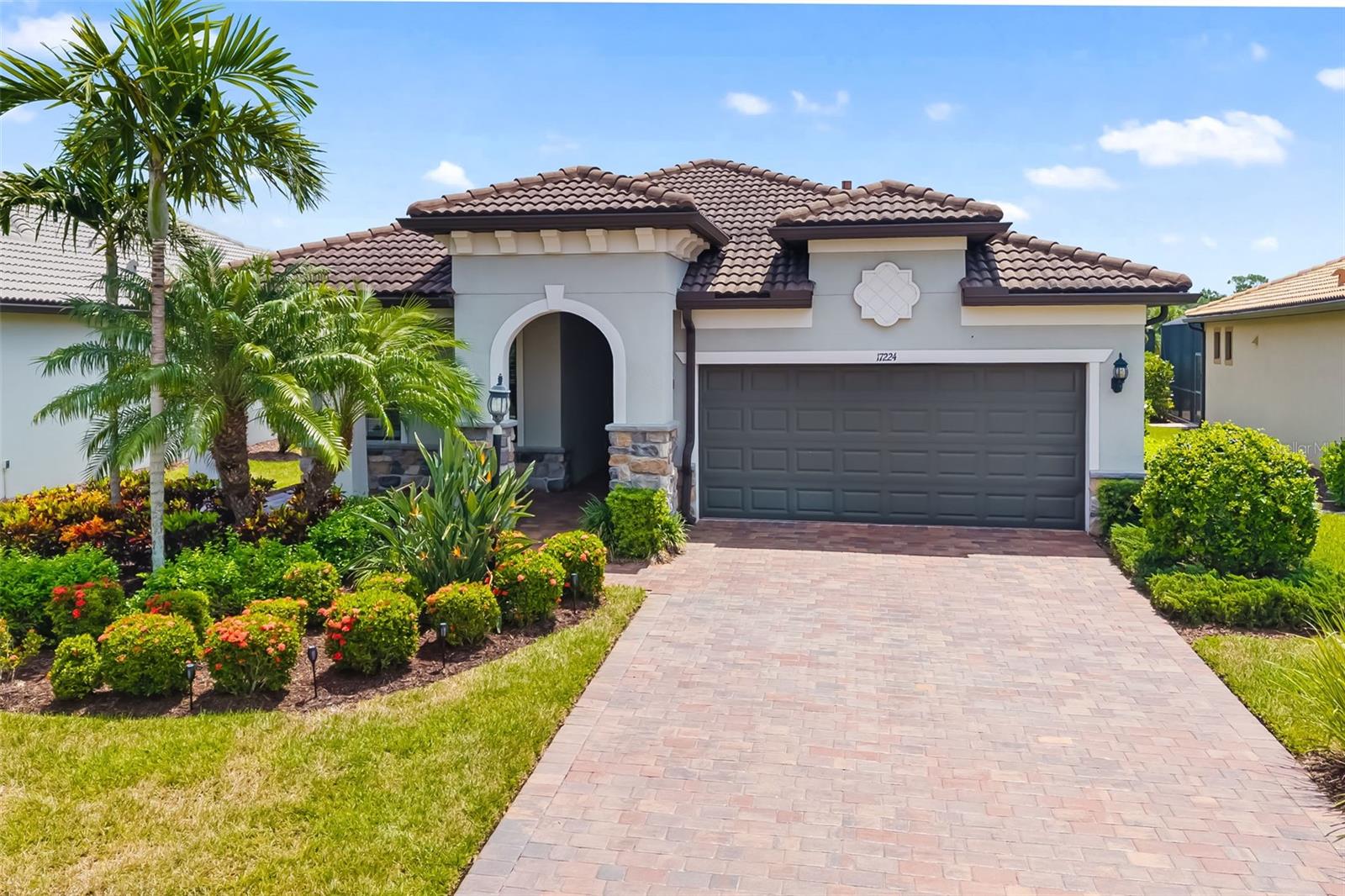 One or more photo(s) has been virtually staged. Step into this beautifully upgraded Summerwood home, designed with comfort, style, and everyday ease in mind. Located in the sought-after 55+ gated community of Del Webb at Lakewood Ranch, this 2018 residence blends thoughtful design with a vibrant lifestyle. With over 2,000 sq. ft. of living space, the open-concept layout flows effortlessly from the gourmet kitchen to the extended great room and out through sliding glass doors to a covered, screened lanai overlooking a peaceful pond. Perfect for morning coffee, entertaining friends, or simply unwinding, this home offers a backdrop that makes every day feel special. The chef’s kitchen is both functional and inviting, featuring 42-inch cabinetry with pull-out shelving, quartz countertops, stainless steel appliances including a 5-burner gas range, center island with pendant lighting, and a walk-in pantry. The spacious primary suite is a true retreat with a spa-like bath, dual quartz vanities, oversized walk-in shower with dual showerheads, and a large walk-in closet. A private guest suite, den with French doors, and smart upgrades such as plantation shutters, crown molding, epoxy-coated garage with golf cart parking, and a whole-house water system add to the appeal. Life at Del Webb means more than a home—it’s a community. Residents enjoy maintenance-free living, 24-hour security, and access to a world-class clubhouse with dining, social events, resort-style pools, tennis, pickleball, bocce, and a full calendar of activities led by an on-site Lifestyle Director. Whether you’re ready for a lock-and-leave home that makes travel easy, space for family visits, or new opportunities to connect with neighbors, this property and community deliver it all. This isn’t just a move—it’s a lifestyle upgrade.