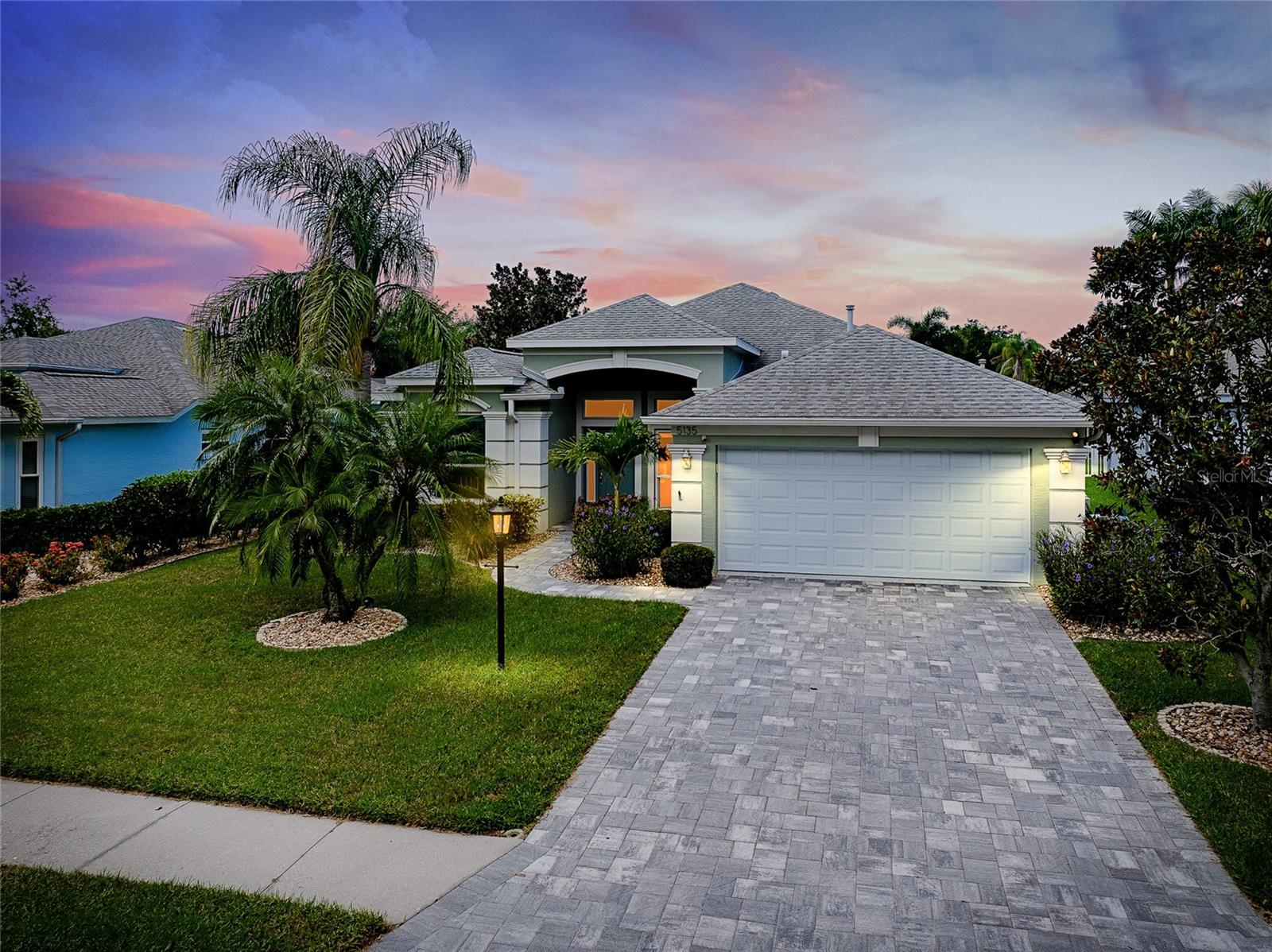 Don’t miss this exceptional opportunity to own a beautifully remodeled home in the highly sought-after, centrally located Carlyle at The Villages of Palm-Aire. This meticulously maintained residence offers 3 bedrooms plus a generously sized den/office, easily convertible to a 4th bedroom with the addition of a closet. With a desirable open and split floor plan, this home is designed for both comfortable living and effortless entertaining. At the heart of the home is a stunning gourmet kitchen, featuring stainless steel appliances, a walk-in pantry, a water filtration system, black quartz sink, and a cozy eat-in area overlooking the screened lanai and large fully fenced backyard. A breakfast bar connects the kitchen to the inviting family room, highlighted by a gorgeous stacked-stone fireplace. On the other side, a separate formal living and dining space adds flexibility and charm. Elegant touches like arched doorways, wainscoting, and tray ceilings enhance the home’s character, while easy-care tile flooring in the main living areas and wood/vinyl/laminate flooring in the bedrooms combine style with practicality. The spacious main gathering room with soaring 10-foot tray ceilings offers a tranquil retreat or the perfect setting for entertaining guests. The primary suite is a private sanctuary with sliding doors to the lanai, a large custom walk-in closet, and a beautifully updated en suite bathroom featuring dual sinks, top-tier finishes, a separate water closet, and walk-in shower. The oversized lanai has polyaspartic flooring and is built with reinforced construction to endure hurricane-force winds, offering both comfort and peace of mind. Step outside to an oversized lush, landscaped backyard filled with mature, fragrant plantings and ample space to add a pool if desired. Enjoy peaceful lake views just beyond the fence. This home has been extensively updated in recent years for your peace of mind, including a newer roof (2019), hurricane-impact windows and doors (2017), and a motion-sensitive fire/security system. The garage is fully equipped with an impact-resistant door, polyaspartic flooring, updated breaker box, utility sink, generator hookup, tool rack, and overhead storage. Located in a friendly, active community with no CDD fees and low HOA dues, residents enjoy access to a community pool and tennis courts. Optional membership to Palm-Aire Country Club is also available, offering access to a clubhouse, swimming pool, two 18-hole championship golf courses, eight lighted Har-Tru tennis courts, and a fitness center. This unbeatable location puts you just minutes from Lakewood Ranch, UTC, Downtown Sarasota, St. Armands Circle, Lido Beach, and the world-renowned Siesta Key—plus quick access to I-75. Schedule your private tour of this remarkable home today—this one won't last long!