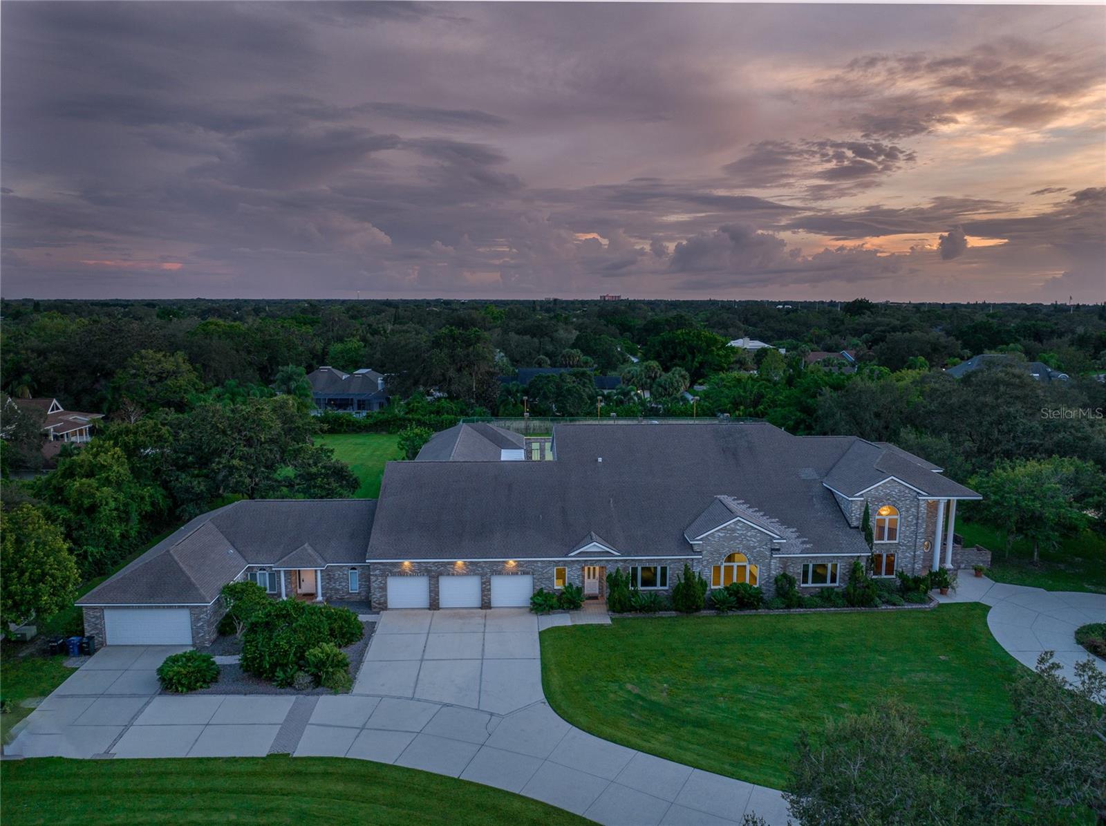 Gated estate with over 12,000 SF of living area in the main house, a guest house, 3,800 SF air conditioned "Man Cave", tennis courts and a bowling alley! This one of a kind custom home is located near Clark and Beneva in A-rated school districts with privacy and seclusion inside of your own 3.4 acre gated estate. The main house features a 2 story foyer entrance, multiple living spaces, great natural light, large game room, the bowling alley, a ground floor master wing, 6 additional bedrooms all with their own en-suites and walk-in closets and a 3 car garage. The guest house is attached with its own entrance as well as a connected back patio and has an additional living space, bedrooms, baths and a 2 car garage. The oversized pool features a heated spa, an outdoor kitchen, a pool house room and 3,600 SF of paver deck area. The grounds have a privacy wall, tennis courts and a 3,800 SF Air conditioned building that could be utilized for additional storage or AC play area.