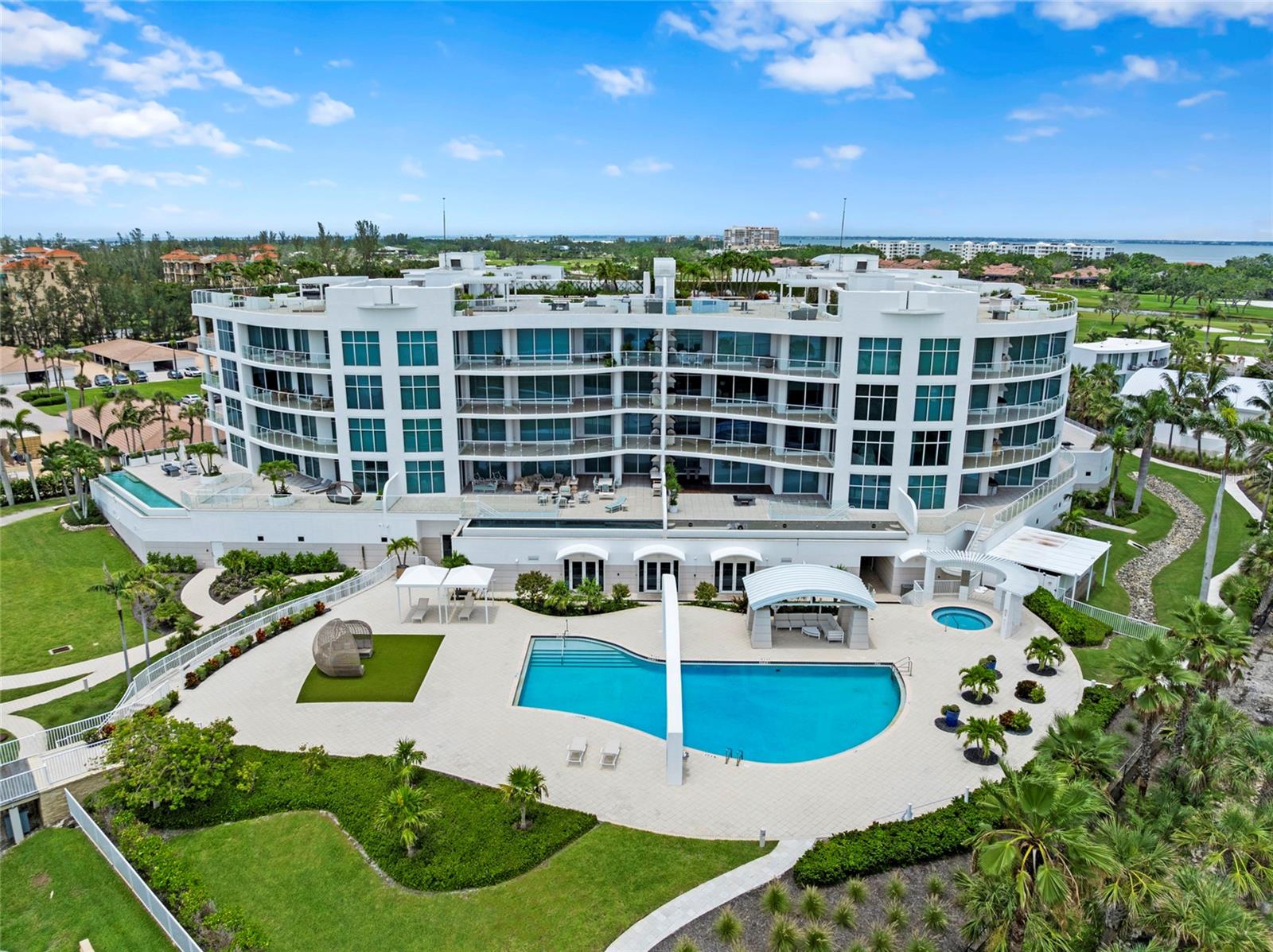 One or more photo(s) has been virtually staged. Looking for your own private Gulf Oasis? Enter your dream coastal retreat in the exclusive Aria community, located on the highly sought-after south end of Longboat Key. This area is especially desirable for its quiet, secluded atmosphere while still offering quick access to the world-class dining, arts, and cultural experiences of nearby Sarasota. This remarkable residence, surrounded by 300 feet of pristine private Gulf-front shoreline, offers a lifestyle unlike any other. As you approach through Aria's gated entrance, you are instantly embraced by thoughtful, timeless design, lush native landscaping, serene walking trails, and a lovingly preserved artesian well—a subtle yet meaningful tribute to the property's rich history. Step into your private elevator and discover nearly 4,000 square feet of exquisitely designed, light-filled living spaces. The expansive foyer welcomes you into an open-concept layout that seamlessly blends a chef's kitchen, spa-inspired bathrooms, and elegant living areas, all thoughtfully crafted for comfort and effortless entertaining. Towering 9+ foot ceilings, floor-to-ceiling glass windows, and wrap-around terraces ensure that the stunning Gulf views are yours to enjoy from every angle. Relax in the inviting family room or host unforgettable gatherings in the grand great room. The kitchen is a culinary masterpiece, showcasing luxurious quartz countertops, solid wood cabinetry for ample storage, and premier Wolf and Miele appliances. The primary suite offers a serene retreat designed for complete relaxation, with an opulent ensuite bathroom featuring two private baths connected by a spacious walk-in shower—an indulgent experience for everyday living. Two additional ensuite bedrooms provide ample space for guests, while a home office or optional fourth bedroom offers flexibility. A bonus room is perfect for hobbies, crafts, or additional storage. Living in Aria means immersing yourself in an unparalleled lifestyle. At the community's heart lies Villa am Meer, a beautifully restored 1935 seaside mansion that serves as the elegant residents' clubhouse. Whether you're entertaining guests or enjoying a quiet evening, you can unwind in the private wine cellar, selecting a bottle to savor on your terrace as the sun sets over the Gulf. Additional resort-style amenities include a beachfront pool and spa, yoga and fitness studios, a massage room, and a serene, service-oriented environment. A private, oversized two-car dehumidified garage offers additional convenience, while a resident caretaker ensures personal service is always just a phone call away. Aria is more than just a residence—it's a way of life. Make 2251 Gulf of Mexico Drive #301 your new home—a place where timeless elegance meets modern luxury. Live the extraordinary story by the sea at Aria.
