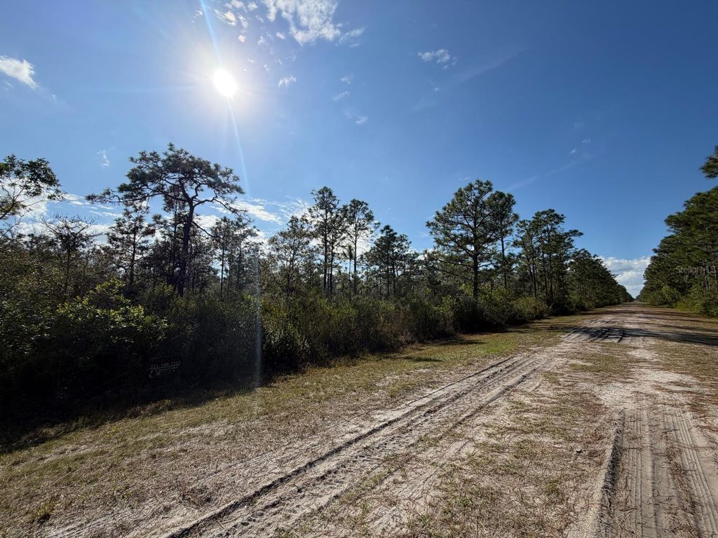 Photo of 405 Bougainville Drive, Indian Lake Estates, FL 33855 (MLS # S5138591)