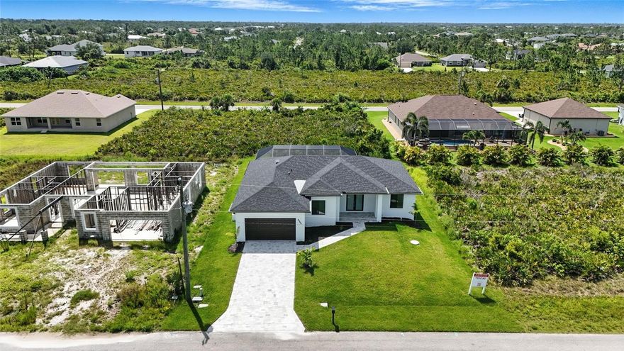 Brand new 3-bedroom + den, 2-bath home offers 1,726 square feet of upscale living space. Located in a quiet and growing neighborhood of Port Charlotte, the home features an open-concept layout, stylish finishes, porcelain tile throughout, quartz counter tops and high ceilings. The split-bedroom design provides privacy, while the covered lanai and private pool offer a perfect space for outdoor enjoyment. Built with impact-resistant doors and windows. Ideal for full-time living or investment. OWNER FINANCING AVAILABLE.