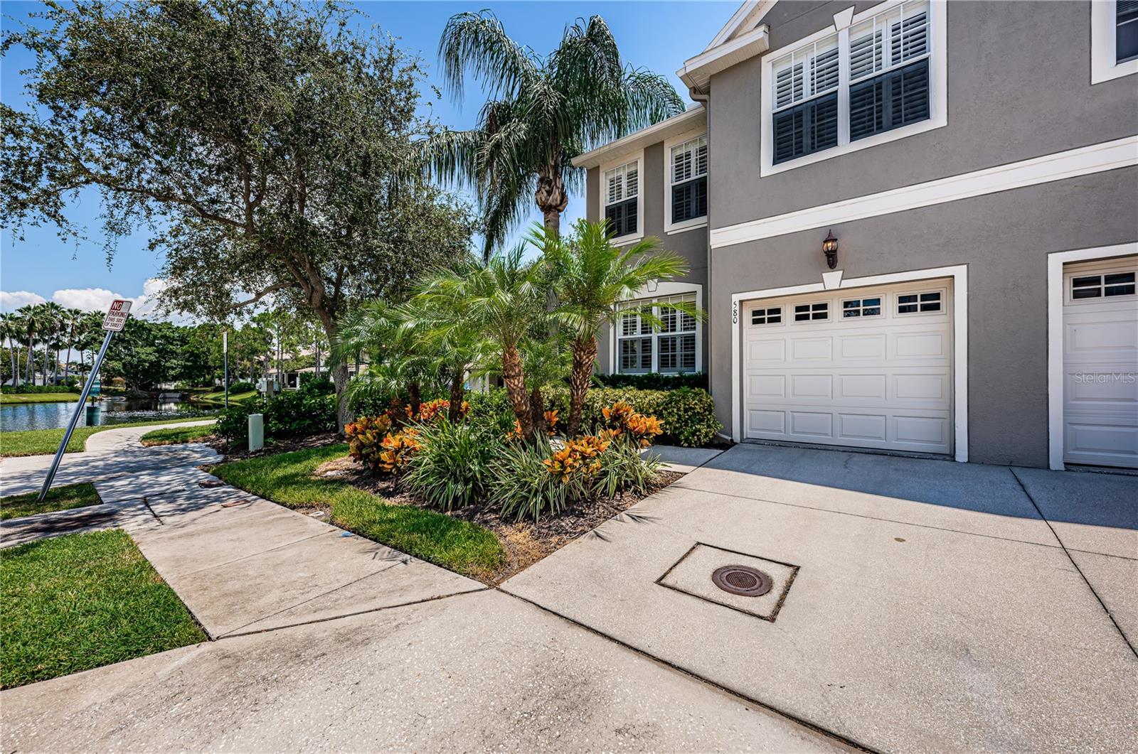 Welcome to this 3 bedroom, 2.5 bathroom, 1,618 sq ft townhome in the sought-after community of Wyngate at Brighton Bay. This is a larger end unit with a serene pond view! Upon entry, you’ll find a spacious living area that opens up to the nicely updated kitchen with white wood cabinets, granite countertops, newer stainless-steel appliances, and room for a dinette. Off the kitchen is a screened patio perfect for extending your entertaining space or enjoying your morning coffee. You’ll find a half bath downstairs along with a bonus space that could be used as a game room, home office, or guest space. Plantation shutters throughout the home and ceiling fans in every room! All 3 bedrooms are upstairs for added privacy. The primary suite has a walk-in closet, dual vanity, and luxury walk-in shower. There is a shower tub combo in the second full bath across from the second and third bedrooms. The laundry closet is conveniently located on the second floor. Parking is a breeze with a one-car garage, a one-car driveway, and additional public spaces available for guests. Live the resort lifestyle with access to the community pool, hot tub, tennis, pickleball, volleyball, basketball, playground, and fishing pond. Perfectly positioned minutes from downtown St. Petersburg and Tampa, you’ll have quick access to shopping, dining, and entertainment. It’s a perfect location for commuters, close to Gandy Bridge and I-275! Don’t miss your chance to make this beautiful home yours!