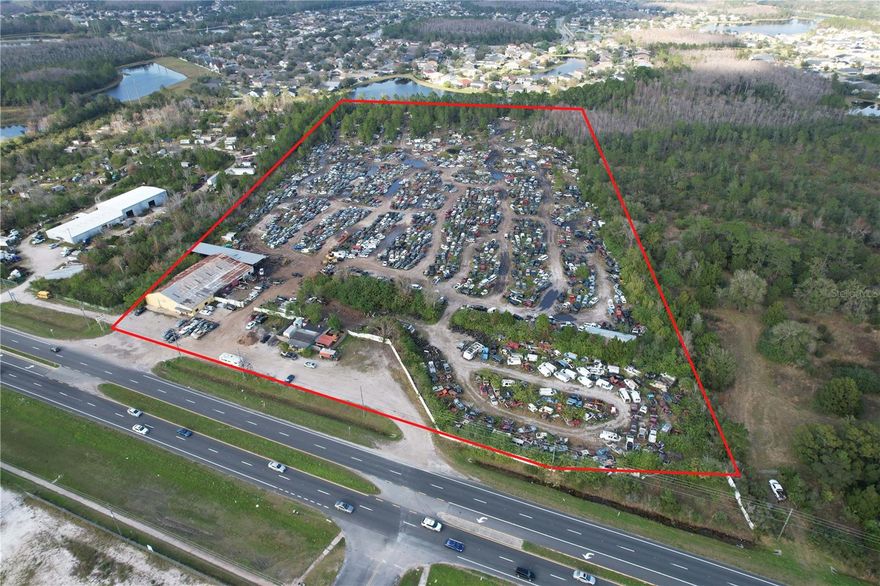 19.40 Acres (837,659 sq.ft) of C-3 Heavy Commercial with 530 Ft of Frontage on busy SR50 with great accessibility having a median cut on both the East and West end of the property. This is the Largest C-3 lot available on the market in East Orlando. There are endless development opportunities with this property. Located between UCF the largest University in the state of Florida and NASA's Kennedy Space Center which is booming with growth and could potentially be the new headquarters for NASA. This could be a prime location for a number of National Tenants. With 2,000+ homes approved in the new 'agri-hood' development The Grow located just 1 mile to the west this large commercial property is a great investment as new development continues to head East down SR50. This property permits outdoor storage of boats, RVs and heavy machinery along with self storage, diesel repair shops, warehousing. Additionally, there is currently still an active salvage license that could be conveyed with the sale of this property. Phase 1 and Phase 2 Environmental are available upon request.