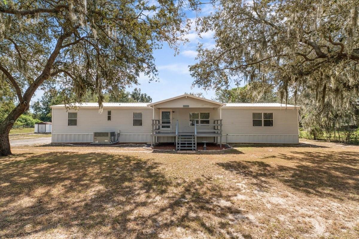 Welcome to 11919 Rhodine Road, Riverview where there's NO HOA!!! This beautifully maintained 1993 Fleetwood Stone Creek double-wide manufactured home offers over 2,000 sq ft of comfortable living space. Featuring 4 bedrooms, 2 baths, and an inviting wood-burning fireplace, this home combines charm and functionality. Enjoy recent updates including new kitchen and laundry room flooring (2024), a stylish kitchen backsplash (2022), french door installed (2019) and updated vinyl skirting. The durable metal roof (2018) ensures peace of mind for years to come. Situated on a spacious 1.02-acre lot, there’s plenty of room to relax, garden, or entertain. A 22x26 detached garage, added in 2012, offers excellent potential for a workshop or hobby space. The property also includes two storage sheds and a RV parking pad, providing ample space for tools, equipment, and outdoor toys. Conveniently located near shopping, dining, hospitals, churches, schools, beaches and major highways—this Riverview gem delivers both privacy and accessibility.