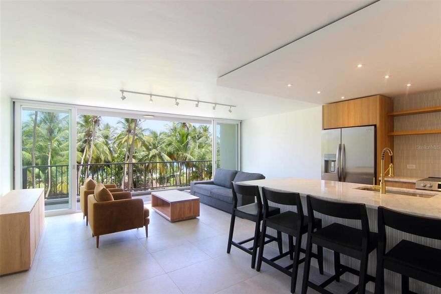 Discover refined coastal living in this newly remodeled two-bedroom, two-bathroom apartment, where Scandinavian architecture meets the Caribbean. Thoughtfully designed with granite bathroom vanities, an oversized dolomite kitchen countertop, rain showers, anti-fog mirrors, warm dimmable lighting, and safety windows, this home blends elegance with comfort.

The condominium offers 24-hour security, a fitness center, lush gardens,  gazebo/bbq, a resort-style pool, and direct access to Isla Verde’s pristine beach. One underground parking space is included. A full generator should be installed by January 2026. Welcome to your beachfront sanctuary.