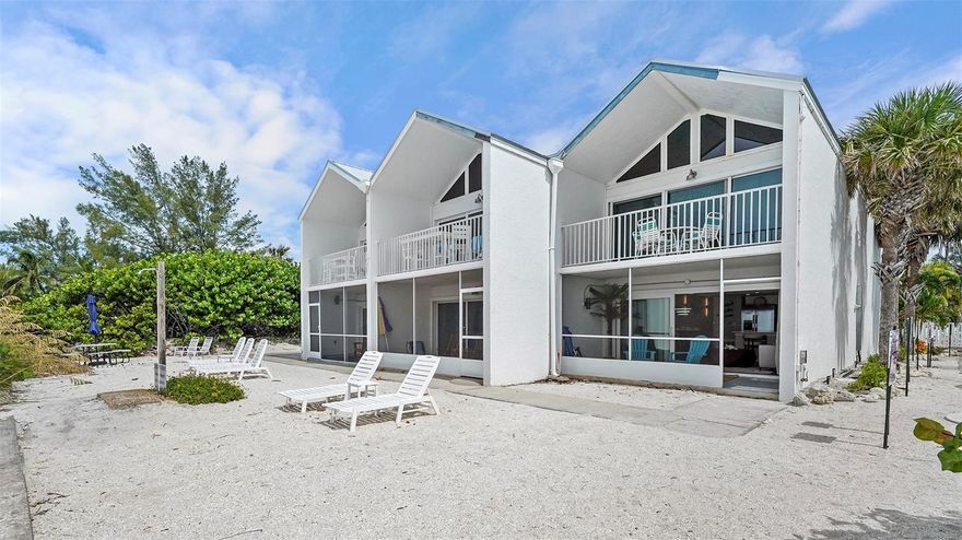 This rare ground-floor, direct Gulf-front residence at The Coconuts offers true toes-in-the-sand access and unobstructed sunset views the moment you walk through the front door. Step from your living room directly onto the sand — no stairs, no elevator — just instant beachfront living in one of the most coveted locations on Anna Maria Island. Fully renovated from top to bottom and sold turnkey furnished, this one-bedroom, one-bath coastal retreat feels like a private beachfront bungalow with the amenities of a boutique resort.
The interior blends modern coastal design with relaxed island luxury: wide-plank luxury flooring, custom cabinetry, herringbone backsplash, quartz countertops, stainless steel appliances, and sleek black fixtures create a refined, high-end finish throughout. Floor-to-ceiling impact glass sliders fill the home with light and open to a private beachfront patio that extends seamlessly to the shoreline. The spa-style bath features porcelain marble tile, a frameless glass walk-in shower, and premium hardware for a polished, contemporary feel. Every space has been thoughtfully curated for comfort, style, and durability in a coastal environment.
Beyond the walls of the condo lies everything that draws people from around the world to Anna Maria Island: miles of sugar-white sand, calm turquoise Gulf waters, walkable seaside dining, island-style boutiques, bike paths shaded by palm trees, sunset beach bars, and an unhurried pace that still feels like “old Florida.” Mornings begin with shell walks at sunrise, afternoons unfold between the water’s edge and your patio loungers, and evenings end with postcard-worthy sunsets just steps from your door. There is no need for a car once you arrive — everything is truly at your fingertips.
The Coconuts is one of the few communities on the island that allows nightly rentals, making this property just as strong of an investment as it is a private coastal escape. Currently operating as a vacation rental with projected 2026 income of $175,000, this residence offers both lifestyle and portfolio value in equal measure. Direct, full Gulf-front condos with true ground-level walkout access rarely become available, making this an exceptional opportunity to own a premiere slice of Anna Maria Island’s shoreline.