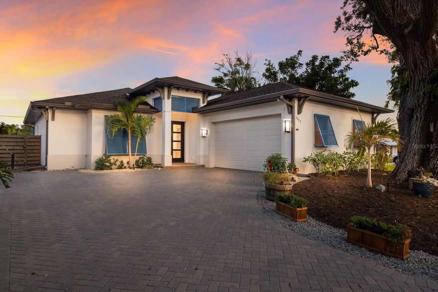 This stunning one story custom-built home completed in 2020, offers the ideal blend of modern design, high-quality construction and an unbeatable location. In the sought-after Southside Elementary School district, this three-bedroom, three-bath residence plus dedicated office is just minutes from Siesta Key, downtown Sarasota and Sarasota Memorial Hospital, placing you at the heart of everything that makes Sarasota exceptional. Designed for comfort and style, this home features a seamless open floor plan with soaring ceilings, corner pocket doors in the office and abundant natural light. The spacious kitchen is a chef’s dream, boasting quartz countertops, an oversized island, custom cabinetry and top-tier appliances. The smoky mirror wall at the entryway and built-in bookshelves add unique character, while recessed LED lighting enhances the contemporary ambiance. Step outside through the expansive sliding glass doors to your private backyard retreat. The pool and spa are surrounded by lush traveler palms, creating a serene, tropical escape. The fully fenced-in yard and generous patio space make this the ideal setting for entertaining or unwinding in privacy. Additional highlights include solid block construction, hurricane/impact-rated windows and doors, a two-car garage with additional driveway parking and a paver driveway for an elegant touch. With no HOA or CDD fees, this move-in-ready home offers the rare opportunity to experience luxury living in one of Sarasota’s most desirable neighborhoods. Schedule your private tour today!