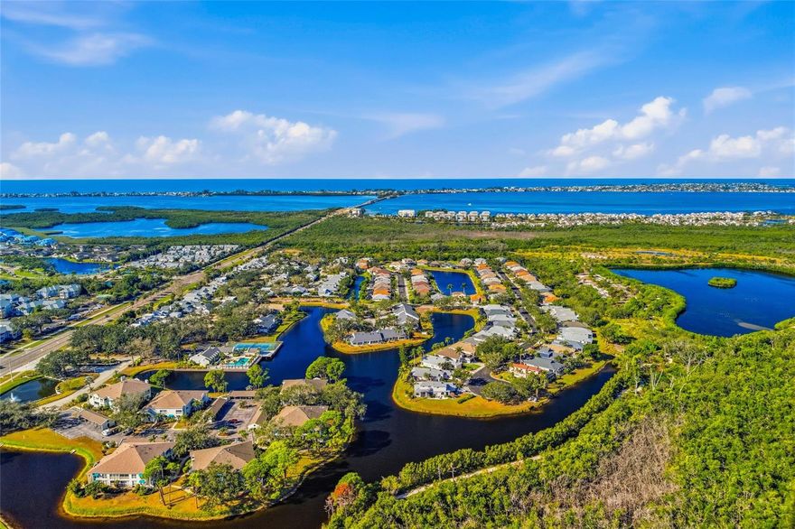 BEAUTIFUL open and bright 1st floor condo with breathtaking lake and preserve views! This meticulously remodeled residence is filled with natural light from abundant windows and offers peaceful views of the water and surrounding trees, where beautiful birds can be seen right outside. Featuring over 1,400 square feet, the home showcases quality cabinetry, upgraded appliances, and engineered wood flooring.  And it comes with a carport and 2 outside storage rooms for bikes and beach stuff! The versatile office/Florida room provides another stunning vantage point of the lake, making it an ideal space for working, relaxing, or entertaining. Located just 1.5 miles from the Anna Maria Island bridge and right next to Robinson Preserve, this condo offers the perfect blend of coastal living and nature. Enjoy a peaceful, beautifully landscaped community that feels like having your own private yard right on the lake. Residents also enjoy access to a waterfront clubhouse with pool, grill, pickle ball court, fitness center and sauna, library, pool table and kitchen for owners to use. A truly special opportunity in a prime location!