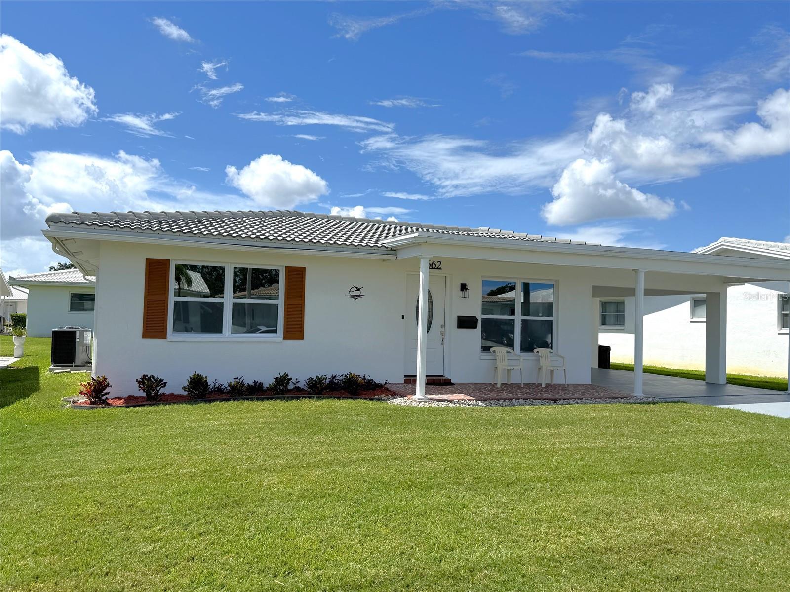 Location, Location, Location! Discover The Mainlands of Tamarac! You will love this Completely updated turn-key easy to maintain home featuring: All New High Impact Hurricane Windows, Gorgeous New front entry door with glass oval inlay, New Roof, New HVAC, and New Water heater. The Kitchen is a real showstopper with all new modern shaker cabinetry, Quartz Counter tops and backsplash, sleek Whirlpool Stainless Steel appliances, low profile microwave and deep sink, complete with a large breakfast bar open to the Family room. This open floor plan has so much to offer with all new Luxury Vinyl Flooring, baseboards, Interior paint, outlets and light switches. All new ceiling fans, light fixtures and recessed Led lighting. The bonus room with French doors would be perfect for a craft room, home office or gym. Large indoor laundry room featuring washer and dryer. Master bedroom features a large wall to wall closet. The guest suite also has a large closet with recessed lighting. Updated bathroom hosts a new vanity, updated hardware, oval mirror, stylish new lighting, additional mounted cabinet and updated toilet. Large carport hosts floor to ceiling storage cabinets for all your storage needs. Nestled in a vibrant, amenity-rich community, you'll enjoy easy access to Mainlands Sparkling Community Heated Pool and Clubhouse, Mainlands Golf Course, Freedom Lake Park that offers: Dog Park with large, fenced exercise space separated for large and small dogs, hydrants, watering holes, and plenty of shade for your pets, covered outside fitness stations, fishing, grilling, picnic tables, pavilions, new playground, walking track and the Korean War Memorial. This home's ideal location puts you close to all the best that the area has to offer - from world-class Gulf Beaches, Sam’s Club, Coffee Shops, Fitness Centers, shopping, dining, Helen Howarth Park, Equestrian Trail, Dog Park, and Forbes recreation area, I-275, St. Pete/Clearwater and Tampa International Airports. Whether you're an adventure-seeker or simply seeking a peaceful oasis, this home offers the perfect setting to elevate your Florida lifestyle.