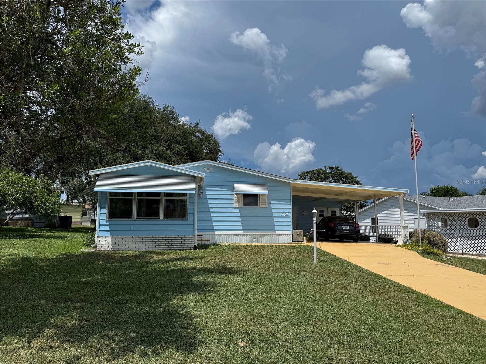 NO BOND - Village of Country Club Hills (Orange Blossom Gardens) - Nice 2 Bedroom, 2 Bath Manufactured home with carport and golf cart garage. A/C and Roof installed in 2016 according to the Lake County Assessor, new windows in lanai, newer Laminate flooring. Home does need some finishes and updates and a few repairs. Start enjoying the VILLAGES Lifestyle today - golf, pickleball, pools, bocce, shuffleboard, etc. Close to The Villages Entertainment center at Spanish Springs town square with lots of shopping and dining as well.
