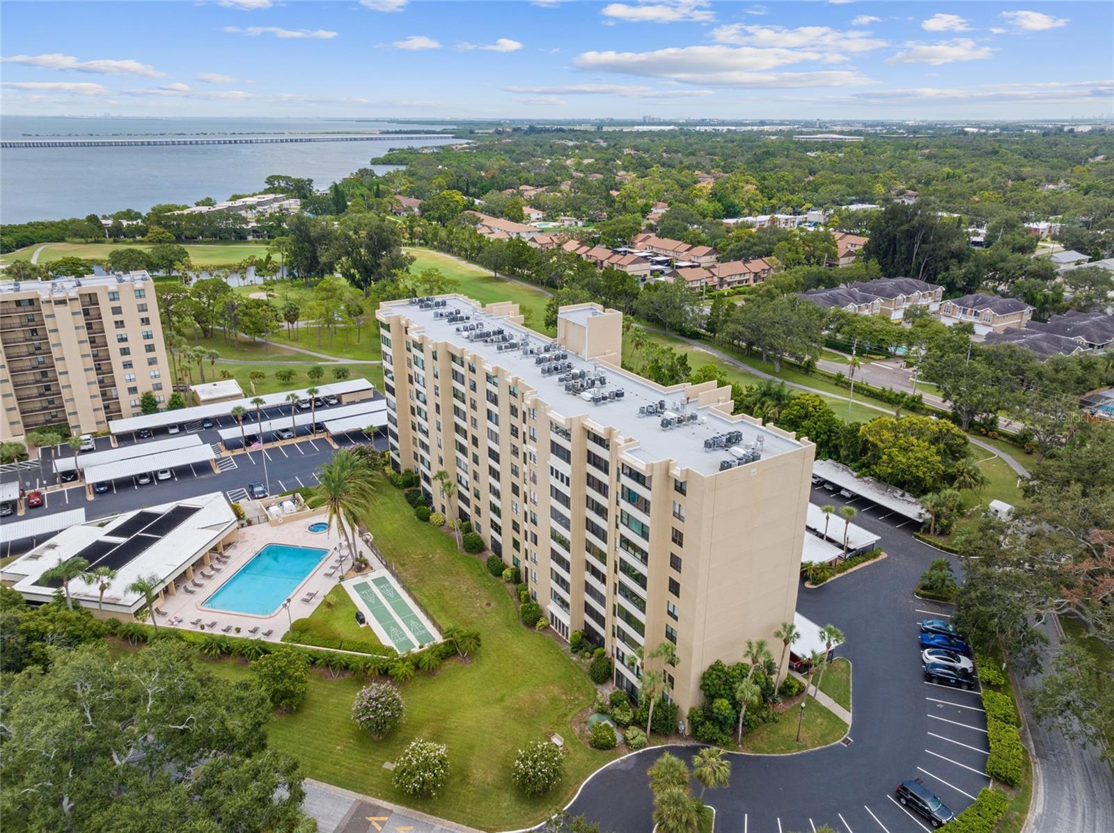 This bright and cheerful 2/2 Cove Cay gem is priced to sell! Brand new wood flooring and a panoramic view of the scenic golf course, pool, clubhouse and tropical landscaping. The large combined living/dining area opens up to the enclosed glass and screened balcony where you could use this room as balcony or as an alternate room for a myriad of possibilities. The primary bedroom, with a walk-in closet, is spacious enough for a king-size bed. The window has a scenic view as well. The second bedroom is spacious with a nice-size closet. This condo comes with it's own personal -- and very convenient -- laundry/storage room across the hall. A carport for parking is included as well. What makes Cove Cay so special are it's many resort-like amenities. Although golfing, dining and the marina are not included in the association fees, the gorgeous recreation area with heated pool, spa, "gathering" room, pool table and fitness room are. For an extra fee, you can use the golf practice facilities 7 days/week, you can store your boat, trailer or kayak at the marina, or you can rent a jet ski, pontoon boat or other rental boat. Cove Cay is conveniently located to world-renowned beaches, restaurants, shopping, airports, fine dining, recreational events, as well as downtown Clearwater, St. Petersburg, or just across the Bay to Tampa. It is not uncommon for word "paradise" to be used when describing Cove Cay. Cove Cay defines the Florida lifestyle. You, too, can enjoy a piece of paradise as well.