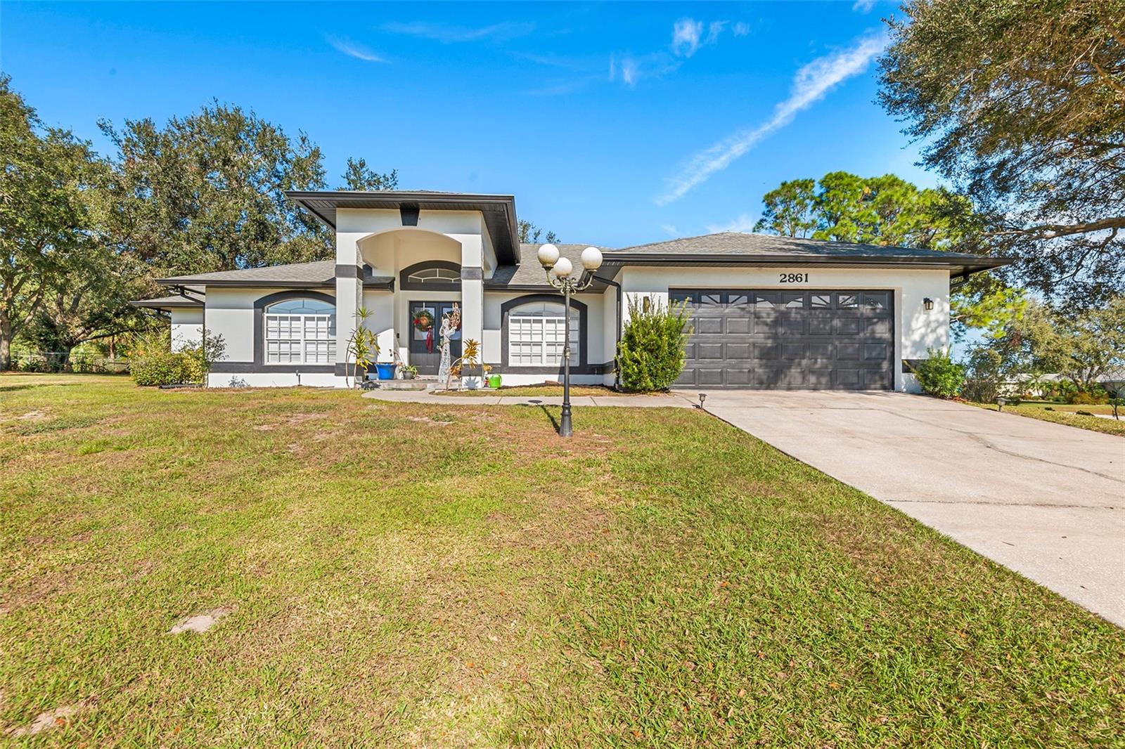 Nice Price Reduction! Welcome to a relaxed, country feel. If you’re looking for a little more freedom than what you find in your typical stuffy subdivision of cookie cutter homes, then this home is for you! Welcome home to this 3-bedroom, 2.5-bath POOL home with a den/office. This fantastic home is situated on a half-acre corner lot and has beautiful landscaping and amazing curb appeal. Inside you will find a fantastic floor plan with 2,128 sq ft. of living space. It has cathedral ceilings and ceramic wood-look tile throughout the main living areas and carpet in the bedrooms. There is a formal dining room, as well as an eat-in kitchen that features GRANITE countertops, a breakfast nook overlooking the pool, ample storage space in modern cabinets and updated appliances like stainless steel GE appliances including refrigerator and an over-sized microwave oven. The master suite has beautiful views from the lanai, an adjoining master bath featuring dual vanities, a beautifully tiled walk-in shower, and walk-in closet. Additionally, there are two large bedrooms with ample closet space, and beautiful den with French doors for your office needs or for additional storage. This home is move-in ready, with a built-in laundry area. Enjoy the pool on a hot summer’s day, or host a BBQ poolside. The homeowner has kept the home immaculately maintained and it is pre-wired for a generator outside and the water heater is a heat pump hybrid unit keeping the electric bill around $150/month. Enjoy living away from the hustle and bustle, yet close to golfing, lakes and quick commute to HWY 27 for easy access to most areas.