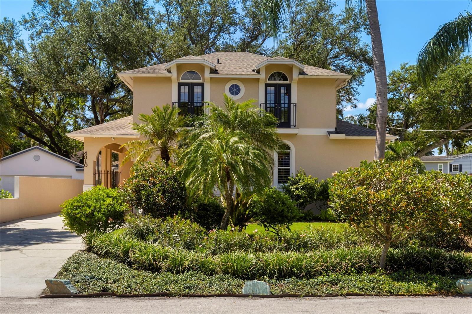 Open House Cancelled, Saturday 8/23/25. Call (813) 520-0236 for private tour! Experience Sunset Park living in this ELEVATED, thoughtfully designed home with NO flooding history! This stunning 3 bedroom, 2.5 bathroom home spans 2,492 sq. ft., with a den and oversized two-car garage, showcasing luxury upgrades and storm-ready construction for both elegance and peace of mind. As you arrive, the home greets you with impressive curb appeal, beautifully landscaped grounds with an irrigation system, and a long driveway offering ample parking. A gated entryway leads to the front door, where clay tile flooring introduces the home’s refined interior. Inside, vaulted ceilings and an open floor plan separate the living areas from the bedrooms. The living room features travertine stone floors and a wood-burning fireplace, creating a warm and inviting centerpiece. The chef’s kitchen is a showpiece, complete with a built-in paneled refrigerator with separate ice drawer, KitchenAid gas range, convection oven, warming drawer, microwave convection oven, two Fisher & Paykel dishwashers, prep sink, wine cooler, marble backsplash, quartz countertops, and an eat-in area, perfect for entertaining or everyday living. Adjacent is a versatile office/den ideal for work-from-home or study. The first-floor primary suite offers a spa-like retreat with a jetted tub, double vanities, and two walk-in closets. Upstairs, two additional bedrooms share a beautifully remodeled full bathroom. Practical features include a spacious laundry room with abundant storage, a security system with Ring cameras and floodlights, and an irrigation system for effortless maintenance. Outdoors, the private backyard is designed for year-round enjoyment. French doors open to a covered porch with a mosquito misting system, overlooking a resurfaced Chicago brick pool with a built-in bench. Juliet balconies, a gated fence for privacy, and ample space for seating and relaxation complete this outdoor oasis. The oversized two-car garage offers ample storage and convenience. With meticulous updates and storm-ready construction throughout, this home delivers unparalleled comfort, luxury, and security. Located in the heart of Sunset Park, one of the most desired neighborhoods of South Tampa, this home is just minutes to the Selmon Expressway, less than a 10-minute drive to both the Gandy and Courtney Campbell Bridges, under 13 minutes to Downtown Tampa, less than 10 minutes to Tampa International Airport, and minutes from the city’s finest dining, shopping, and entertainment options. Enjoy the combination of prime location, a spacious and beautifully upgraded home, and elevated living with no past flooding! This is it. Schedule your private tour today!