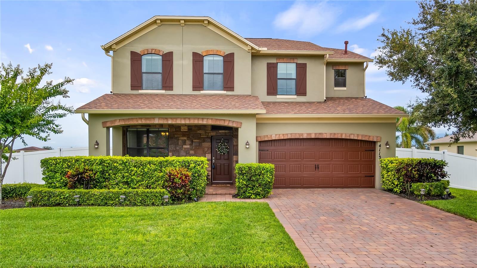 Stunning 4-Bedroom Home in Desirable Gated Community! Step into this immaculate home where modern elegance meets comfortable family living. This exceptional property offers incredibly flexible living spaces designed to adapt to your family's evolving needs, making it the perfect sanctuary for both everyday life and entertaining. The heart of the home features a magnificent large family room bathed in natural light from numerous windows, creating a bright and welcoming atmosphere throughout the day. Adjacent to this space, you'll discover a versatile room separated by an attractive knee wall accented w/elegant columns to create your ideal space whether you envision a playroom, games room (bring a pool table), formal living area, or dedicated homeschool space. Modern conveniences enhance the family room experience w/built-in ceiling speakers for your favorite music and sleek contemporary fans that provide both comfort and style. The home's thoughtful design includes a dedicated office space featuring custom built-in desk, w/cabinetry, and an impressive coffered ceiling. The gourmet kitchen stands as a masterpiece of design and functionality, showcasing gorgeous espresso cabinets w/sleek hardware that beautifully complement the eye-catching tiled backsplash and luxurious granite countertops. The spacious island serves as both a preparation area w/convenient sink and a social hub w/seating at the breakfast bar, illuminated by pendant lighting. Premium stainless steel appliances include a built-in oven, gas cooktop and French door refrigerator, while a generous walk-in pantry ensures ample storage for all your culinary needs. Retreat to the magnificent primary bedroom suite, a truly massive space featuring pretty coffered ceilings and an enormous walk-in closet that provides exceptional storage and organization. The luxurious en-suite bathroom serves as your personal spa w/relaxing soaking tub, and an exquisite tiled fixed-glass shower featuring dual shower heads including an indulgent rain head. Three additional well-appointed bedrooms upstairs each offer their own unique character and charm. One bedroom boasts a convenient walk-in closet and features a beautiful accent wall w/custom trim patterns that add architectural interest. The second bedroom includes a thoughtfully designed recessed area that creates the perfect nook for a desk or built-in bookshelf, while the third bedroom showcases classic wainscoting that adds timeless elegance to the space. Indoor and outdoor entertaining become seamless w/sliders that connect the bonus room and kitchen to your private outdoor oasis. The covered porch and patio have been upgraded with beautiful pavers, creating an elegant foundation for outdoor dining and relaxation. The fully fenced backyard provides privacy making it an ideal playground for pets and play. The property's location places you just blocks away from convenient shopping centers and diverse dining options, while residents enjoy exclusive access to the community pool, cabana, and playground facilities. Location couldn't be more convenient for Central Florida living-Walt Disney World is less than 30 minutes away, all major attractions plus Orlando International Airport accessible within 45 minutes, perfect for both residents hosting visiting guests. The seller is committed to helping you make this dream home a reality and is willing to assist w/a rate buy-down to make your financing even more attractive. Call and let's be creative!