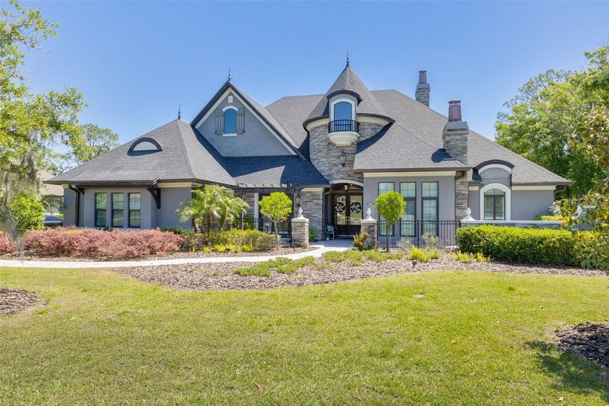 Exclusive Magnolia Farms is a gated community with only 11 homes. The elegant wooded entrance embraces you with natural Grand Oak trees, which are throughout the property.  It is tucked away in Northwest Hillsborough with easy Tampa access.  This is an Adobe, custom-built home with architectural features and high-end finishes throughout the home.  The year built is 2018.  5 bedrooms, 3 1/2 bathrooms, 3 car oversized garage, and expansive driveway to accommodate additional vehicles and guests.  The paved front walkway leads to the double-front-entry doors which open into an elegant entry hall with wood ceilings and art niches leading you into the ample Living/Dining Room.  It's easy to miss all the beautiful architectural features, such as the wood-beamed ceiling, a gas fireplace built in niches, etc., as the French doors lead your eye out across the pool/spa to the private wooded backyard. The front guest bedroom with double doors, would be perfect for a dedicated office or den.  The main bedroom ensuite has double walk-in closets, a custom closet system, French doors, and a tray ceiling.  The main bath features double sinks, a separate W/C, a free-standing tub, and a frameless glass shower enclosure with a rain shower.  The chef's kitchen has an oversized island with a sink and granite countertops. There is a 6-burner gas cooktop, a pot-filler, a decorative vented hood, a built-in convection oven, and a microwave.  There is an additional porcelain farmer's sink.  There is a spacious walk-in pantry that has custom built closet system, a second full refrigerator and a window, which keeps it light and bright.  The expansive custom-built breakfast nook with a built-in banquette is surrounded by a large picture window that floods the kitchen and family room with light.  French doors lining the family room and living room seamlessly pull in the large covered lanai, for a sense of indoor-outdoor living.  The Custom pool and spa is the centerpiece of the outdoor living space.  There is an outdoor kitchen with a gas grill that runs off the propane tank.  There is a mosquito-misting system, for year-round enjoyment of the outdoor space.  Beautiful outdoor lighting,  lushly landscaping, and a bose speaker system, all  make this outdoor space a great place for entertaining and enjoying family time.  Heos system on side wall in kitchen.  Turn any stereo system into a wireless zone. Play your favourite music from a range of streaming services as well as your smartphone, tablet, USB drives or other external device. Control your Denon receiver, integrated amplifier or mini system right from the HEOS app.  PLEASE READ DESCRIPTIONS UNDER PHOTOS.  PLEASE SEE FLOOR PLAN FOR ADDITIONAL INFORMATION.
Magnolia Farms is in an A-grade school district. https://www.hillsboroughschools.org/ Magnolia Farms is 25 minutes from Tampa International Airport, five minutes from the Suncoast Trail, and 20 minutes to the Tampa Premium Outlets.