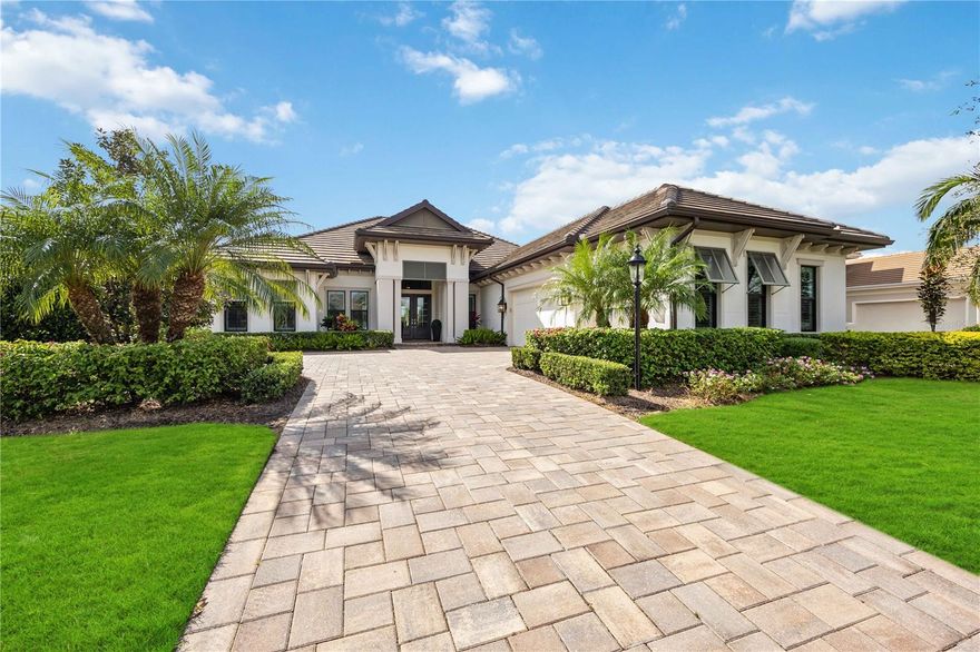 Step into a turnkey dream nestled in a prestigious GOLF COMMUNITY—where your tee time is just as effortless as unpacking, because this stylish home comes FULLY FURNISHED and ready for you to enjoy! Experience LUXURY LIVING with elegant upgrades and designer touches in every corner of this stunning 2018-built LEE WETHERINGTON Saviano model. Set on a prime waterfront lot in the exclusive, MAINTENANCE-PROVIDED, Eaglescliffe community of Country Club East in Lakewood Ranch. The open-concept layout highlights a sleek, modern kitchen featuring custom solid white wood cabinetry that extends to the ceiling, pristine white quartz countertops, premium GE Monogram stainless steel appliances, a butler's pantry with wine cooler, and soft-close drawers and cabinet doors. Seamless indoor-outdoor living is made possible by pocket sliders in the great room and disappearing sliders in the dining room, both leading to the expansive covered lanai. Outside, a heated SALTWATER pool and spa with a stunning fire pit bowl take center stage in a tranquil retreat surrounded by travertine decking and tile, all framed by panoramic screens showcasing breathtaking lake views and vibrant sunset skies. An outdoor kitchen with leathered granite counters, a tiled backsplash, a vented hood, and a Sedona by Lynx grill makes this space perfect for year-round entertaining. The luxurious master suite offers double doors leading to a spacious bedroom with a coffered ceiling and crown molding. The master bath is a spa-like haven with a large glass-enclosed shower, a freestanding tub with custom tile detail, and an expansive vanity with dual sinks and abundant soft-close storage. Additional features include lush, professionally landscaped grounds with lighting, a paver driveway, solid core eight-foot interior doors, epoxy-coated garage floors with an electric car charger, a security system and camera system, and plantation shutters throughout. Don’t miss this remarkable opportunity to enjoy luxurious living near all the vibrant offerings of Lakewood Ranch and the gorgeous Gulf Coast beaches.