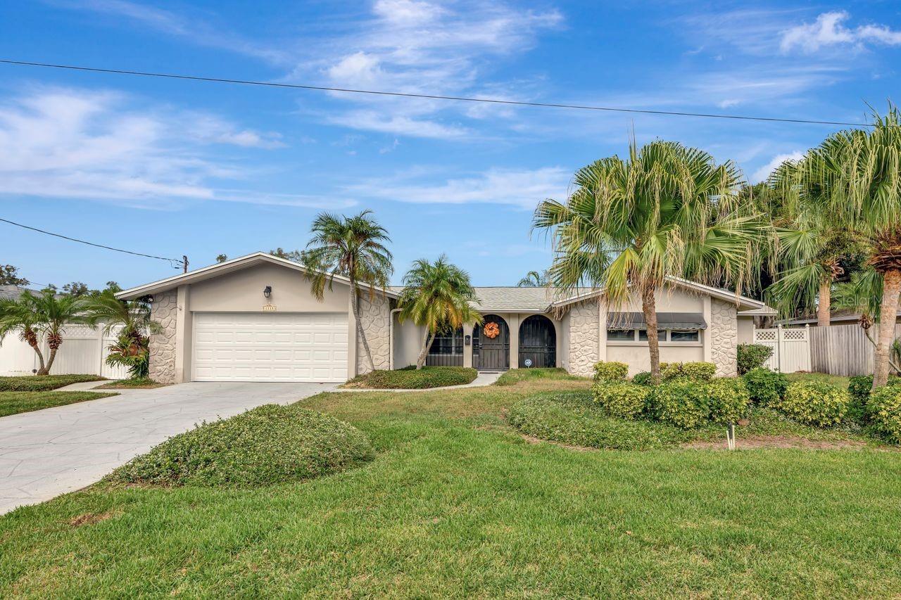 Waterfront home in North East Park Shores offering floor to ceiling views from multiple rooms of the serene saltwater canal. Protected mangroves across the canal ensures your privacy. 
Approximately 2,935 square feet of living space, this 4-bedroom, 3-bathroom house offers a versatile split floor plan with two en-suite bedrooms. The home features a newer roof with a transferable warranty, providing peace of mind for the next owner. Enjoy the tranquility of watching dolphins and manatees from the private pool, which is complemented by a hot tub and paved deck. The home's front porch is screened, allowing for comfortable outdoor enjoyment.
The primary en-suite boasts a Japanese soaking tub and a shower.  There are 3 closets in each of the en-suites, offering ample storage space. The kitchen is equipped with new appliances, and the laundry room includes a washer and dryer. For added convenience, the home has a tankless gas water heater and a full-house gas generator.
Unique features include motorized remote-control solar shades in the back of the house, plantation shutters for the front, a custom-built wine rack on the sun porch, and a Murphy bed. The living area features a natural gas fireplace with built-in bookcases, creating a cozy and inviting atmosphere.
The property also boasts a dock with a 10,000-pound boat lift, ideal for water enthusiasts. With its well-thought-out design and array of desirable amenities, this home is an ideal choice for those seeking a comfortable and versatile living experience.
New 40th Ave bridge height has 13 ft clearance(5 ft higher than previous bridge), providing direct access from the canal to the open waters of Tampa Bay.  Bike path from the neighborhood all the way to down St Pete.   Near Tampa International Airport and downtown St. Petersburg, where you can enjoy a plethora of restaurants, shopping, museums, the Pier and much more.