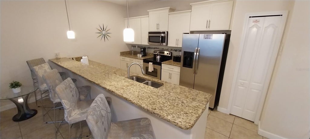 Photo of 3027 Beach Palm Avenue #3027, Kissimmee, FL 34747 (MLS # O6441687)