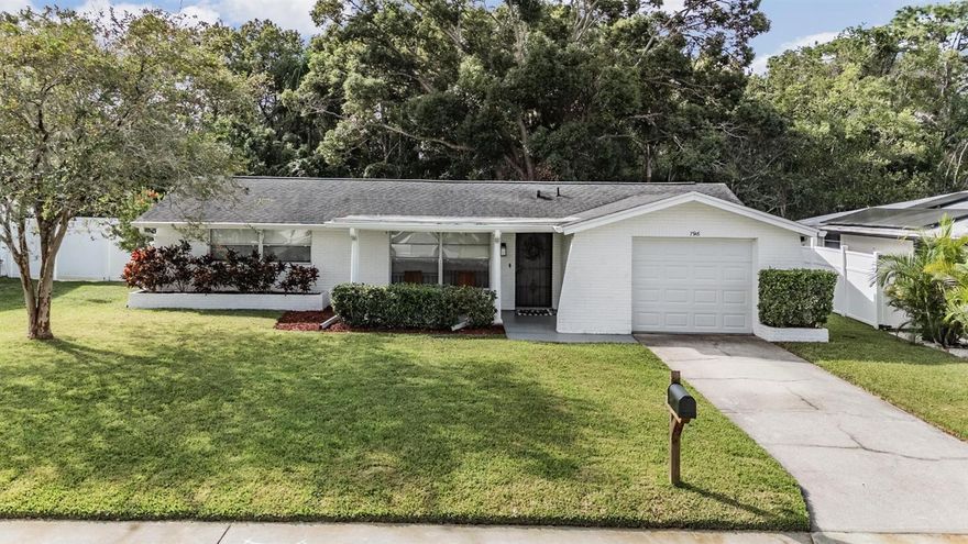 This beautifully maintained two-bedroom, two-bathroom home sits on a serene conservation lot in the highly desirable Magnolia Valley community. From the moment you arrive, you’ll notice the crisp white exterior, lush lawn, and mature landscaping that create charming curb appeal.

Step inside to find an inviting, light-filled living space with large picture windows, neutral tile flooring throughout, and fresh interior paint that brightens every corner. The spacious living room is perfect for relaxing, while the open dining area easily accommodates gatherings and flows into the kitchen.

The kitchen features a large breakfast bar, a cozy eat-in nook, a stylish tile backsplash, and a brand-new refrigerator—ideal for everyday living or entertaining.

Both bedrooms are generously sized, each with cedar-lined closets and warm natural light. The primary bath features cheerful blue tile with a vintage flair, and updated fixtures for a clean, classic look. The second bath complements perfectly with its retro yellow tile and timeless charm—well maintained and ready for your personal touch or to keep as part of the home’s mid-century character.

Enjoy peaceful mornings or evenings on your screened-in patio, overlooking a private, fenced backyard with beautiful conservation views and a fire pit—perfect for Florida outdoor living.

Also included is: 
Newer water softener (2021), Roof (2019), A/C (2016), Garbage Disposal (2025), Exterior paint (2020)

This home has been lovingly cared for and is truly move-in ready—a rare find in this quiet, established neighborhood.

Don’t miss this opportunity to make Magnolia Valley your next home!