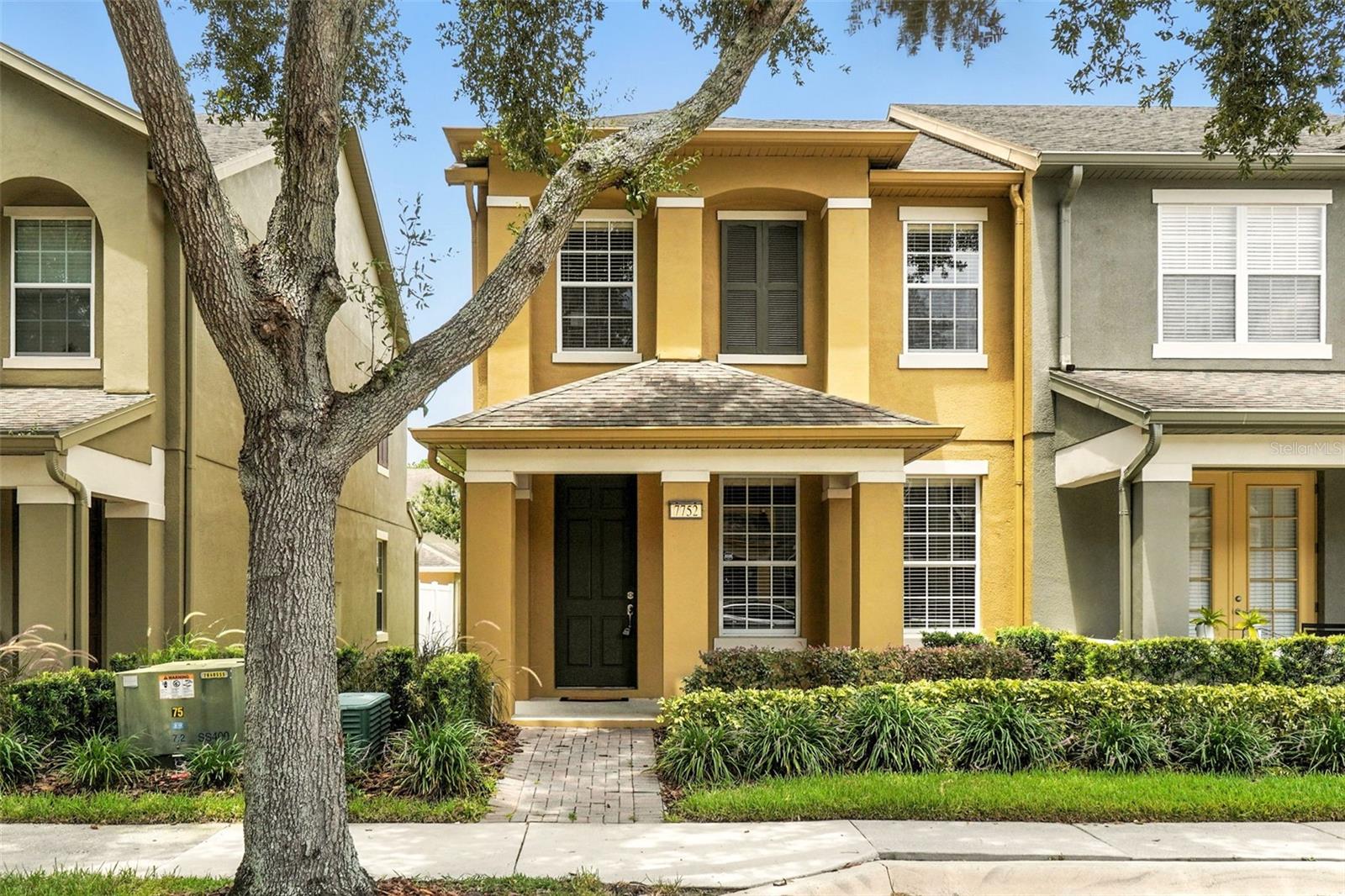 STUNNING WINDERMERE TOWNHOME!! This meticulously maintained end-unit townhome offers three bedrooms, 2.5 bathrooms, and a host of modern upgrades including new LG smart appliances and fresh paint throughout the entire home. From the moment you arrive, you'll appreciate the HOA-manicured landscaping, charming front porch, and striking tall entry door. Inside, the open-concept living and dining areas feature elegant ceramic tile flooring throughout the main level, complemented by stylish chandeliers, light fixtures and space for an impressive 98-inch TV. Just off the living area, you'll find a convenient half bath and a functional laundry room complete with a front-loading washer. The spacious kitchen is a chef’s delight, boasting granite countertops, stainless steel appliances, and a cozy breakfast nook ideal for morning coffee or casual meals. A generous walk-in pantry adds to the home's storage options. Step through triple French doors to a screened-in lanai with brick pavers—perfect for relaxing or entertaining—which leads directly to the two-car garage with an automatic opener. Upstairs, the primary suite features plush carpet, a walk-in closet, and a private bath with dual sinks. Two additional bedrooms provide ample space and share a full bathroom with a large soaking tub. Residents of this well-kept community enjoy a wealth of amenities, including parks, scenic trails, playgrounds, basketball and tennis courts, and a sparkling community pool. The HOA covers lawn care, exterior paint, and roof maintenance for added peace of mind. Ideally situated in sought-after Windermere, this home is close to top-rated schools, major highways, Disney, (you can watch the Disney fireworks from your back porch) premier dining, and shopping. Don’t miss your chance to tour this move-in-ready meticulously maintained gem—schedule your showing today!