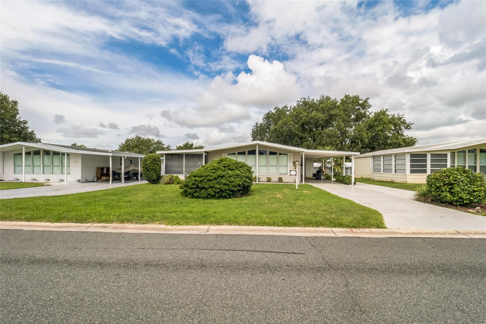 This 2-bedroom, 2-bathroom manufactured home in The Villages offers 1,144 square feet of bright living space. Built in 1985, this fully furnished property features vaulted ceilings, skylights, and golf course views from the enclosed lanai.
The home showcases newer flooring, updated fixtures, and thoughtful improvements throughout. Features include expanded driveway with golf cart pad, large golf cart garage with utility area, and beautiful landscaping with irrigation system.
Currently generating excellent rental income monthly, offering great investment potential for snowbird income. Located in Lady Lake, this community turnkey home is ready for investors or enjoying Villages lifestyle. Great opportunity!