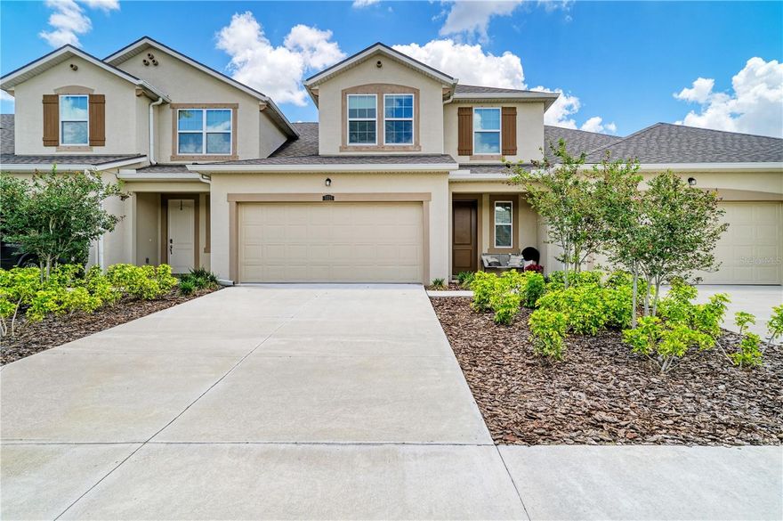 Welcome to Harmony at Lakewood Ranch, where modern comfort, low-maintenance living, and an unbeatable location come together in this beautifully maintained 2023-built townhome located in the community’s newer section. Perfectly positioned near the end of a quiet cul-de-sac, this desirable Sandbar floor plan offers added privacy with no rear neighbors, peaceful lush landscaping views, and a charming covered front porch that creates a warm and inviting first impression. This spacious two-story residence features a screened-in lanai ideal for enjoying Florida’s year-round sunshine, along with a stylish decorative electric fireplace that adds warmth and ambiance to the open-concept living area. Dramatic vaulted ceilings and abundant natural light enhance the home’s airy feel, while the thoughtful layout lives like a single-family home. The sought-after main-level primary suite offers privacy and convenience, complete with a customized walk-in closet and an expansive en-suite bathroom featuring dual vanities, a walk-in shower, and private water closet. The first floor also includes elegant tile plank flooring, a dedicated laundry room with linen storage, and a beautifully upgraded powder bath with designer wallpaper and decorative mirror accents. At the heart of the home, the chef-inspired kitchen showcases quartz countertops, stainless steel appliances, chic pendant lighting, subway tile backsplash, oversized pantry closet, and a spacious center island with seating, all seamlessly connected to the dining and living spaces for easy entertaining. Upstairs, the flexibility continues with two additional open living spaces, ideal for a home office, media room, fitness area, playroom, or study nook, along with two generously sized guest bedrooms connected by a shared full bathroom, providing comfort and privacy for family and visitors alike. Additional highlights include an attached 2-car garage with epoxy flooring, further enhances the single family feel and functionality. Residents of Harmony enjoy resort-style amenities including a zero-entry pool, lap pool, fitness center, playground, and a hidden walking trail leading directly to Roger Hill Park. Ideally located in the heart of Lakewood Ranch, #1 Master planned community for all ages, recognized for its vibrant lifestyle and 150 miles of parks and trails, this home offers convenient access to nearby top-rated schools, The Green with Fresh Market, Waterside Place, UTC shopping and dining, Primrose preschool within two blocks, world-class Gulf Coast beaches, and so much more.
