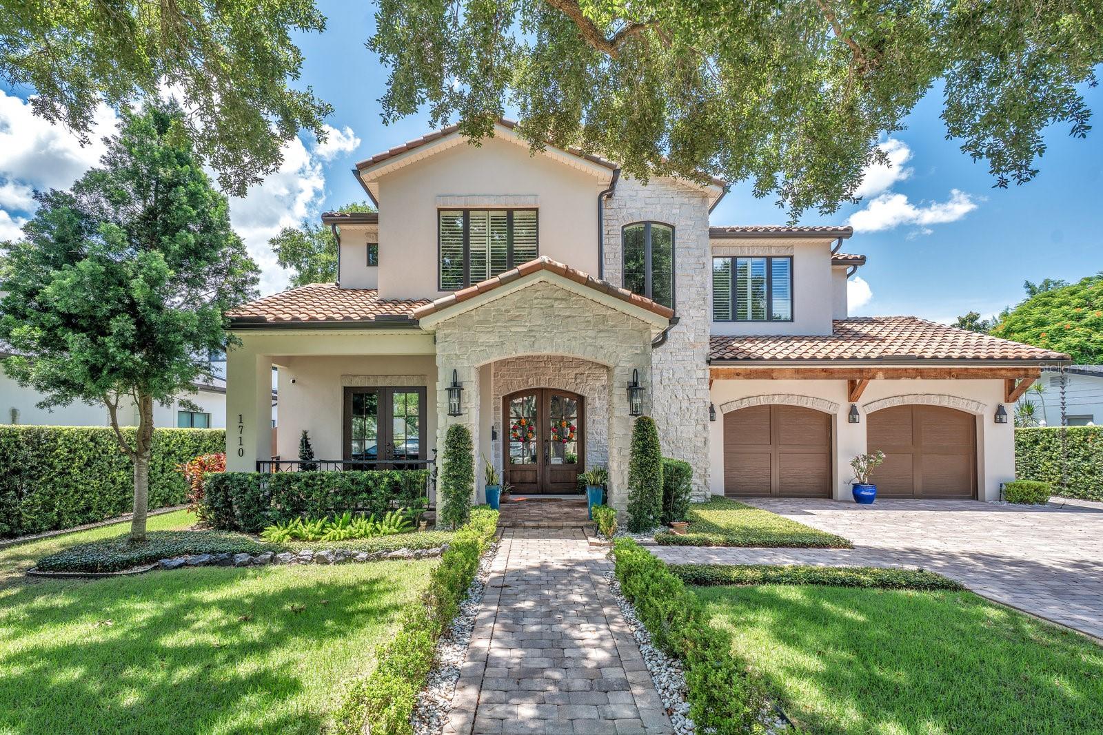 Stunning 2020 Mediterranean Pool Home by M. Lahr Custom Homes in one of the sought-after neighborhoods of Winter Park. Experience unparalleled luxury in this breathtaking exquisite 5-bedroom, 4.5-bathroom home with bonus room that offers a perfect blend of comfort, and functionality. This exceptional residence features high-end designer finishes and exceptional craftsmanship throughout for modern living. As you step inside, you're greeted by soaring ceilings and rich hardwood wire-brushed floors that flow seamlessly throughout the home. Beautiful stone wall with cozy gas fireplace in the family room over looking the kitchen. The gourmet kitchen is a chef's dream, boasting top-of-the-line appliances, a spacious quartz island with ample seating, and plenty of cabinetry for storage. An adjacent fully equipped summer kitchen with gas appliances and remote screens ensures seamless indoor-outdoor living. The spacious master suite is conveniently located on the first floor, offering a serene retreat complete with a spa-like bath and a custom walk-in closet. Office/5th bedroom is on the first floor, providing a private and comfortable space. Upstairs, you'll find three generously sized bedrooms, two full baths, and a bonus/flex room—perfect for a media room, play area, or home gym. Additional highlights include custom plantation shutters throughout, a salt water pool for year-round enjoyment, a two-car garage with plenty of storage options. This home has it all—luxury, convenience, and modern design, all in a prime location.