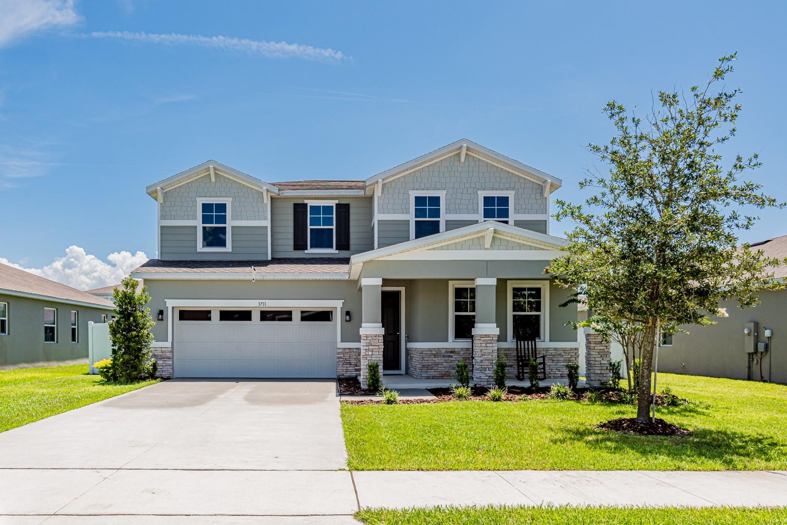 Welcome to this breathtaking Ammolite model. This 5-bedroom, 4-bathroom home designed with space, function, and comfort in mind! Perfect for multigenerational living, this home features a private downstairs mother-in-law suite complete with its own bathroom and separate cozy sitting room. The heart of the home is an entertainer’s dream — an open-concept kitchen, dining, and family room that makes hosting seamless and enjoyable. The kitchen features 42inch white cabinets, a center island, stone countertops and a large walk in pantry. The garage is thoughtfully upgraded with a mini split A/C system and overhead storage, offering the perfect space for a home gym, workshop, or hobby zone. The main floor also comes with 9ft ceilings making your space feel even larger. Upstairs, retreat to the oversized master suite featuring a spa-like bathroom and a walk-in closet spacious enough to be its own room! You’ll also find an upstairs laundry room, a versatile loft space, and three additional bedrooms with a shared full bath. Step outside through your double glass sliders to enjoy your screened-in patio with dual ceiling fans, plus an additional open-air patio, two storage sheds, and a vinyl-fenced yard with dual side gates for easy access. With low HOA Fees, this home is located just minutes from the Lake Harris boat ramp, dining, shopping, and major highways — this home checks every box for comfort, style, and convenience. Additional upgrades include: sprinklers in the backyard, privacy fence with 2 gates on each side, sheds with concrete pads, windows are tinted on all front facing windows, mini split in garage, overhead storage in garage and extended patio. Why wait for a new build home when you can get this one with all the upgrades?! Call to schedule your appointment today!