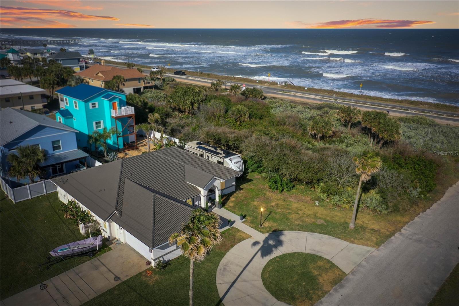 Indulge in Modern Coastal Living: Your Fortress by the Sea Awaits! Step into this extraordinary beach home, a true sanctuary nestled just 100 feet from the ocean. This stunning 2,500 sq ft oasis, boasting 4 bedrooms and 2 bathrooms, epitomizes coastal luxury, strength, and durability. From the moment you enter, the open airy, and relaxing atmosphere captures the soothing ocean breeze, inviting tranquility into every corner. Gourmet Kitchen and Elegant Dining: The chef’s dream kitchen features granite countertops and GE Café black stainless appliances, offering ample space for meal preparation and entertaining. The formal dining room and open-concept layout are perfect for hosting beautiful gatherings with friends and family. Luxurious Primary Suite: Retreat to the oversized primary bedroom suite, with plenty of space for a king bed, sitting area, multiple dressers, or a desk. The primary bath is complete with his and her walk-in closets, a jetted garden tub, and oversized walk-in shower, dual vanities, and a separate toilet room for added privacy. Spacious Outdoor Living: The oversized corner double lot allows for the storage of boats, jet skis, RVs, or trailers, all permitted by city code to be parked behind the forward-most wall of the house. This impeccably built home features a sturdy tile roof, stucco exterior, and hurricane windows rated to 180 mph, ensuring durability and peace of mind. Prime Location and Coastal Lifestyle: Located in a “No flood” zone X as per FEMA mapping, this home offers convenience with an easy walk or bike ride to downtown restaurants, coffee shops, shopping, tennis and pickleball courts, parks, nature trails, the fishing pier, community center, and library. Embrace the coastal lifestyle with long barefoot walks on one of Florida’s only dog-friendly beaches, mornings spent beach fishing, or shell hunting. Enjoy oceanfront beach bars, breathtaking sunrises, and watch whales and dolphins from the beach walkover just 50 steps away from your front door. Investment Opportunity: This beachfront property is not only an ideal permanent residence but also offers an enticing opportunity for vacation rentals. With rentals permitted for six months and one day, this property is perfect for snowbirds, traveling nurses, or extended work-from-home vacations. The extended rental period provides flexibility and convenience for owners, and guests alike, immersing visitors in the vibrant coastal lifestyle of Flagler Beach. Seize the Opportunity: Make this exceptional beach home your own and start living the Florida dream. With its desirable location, upscale features, and extended rental allowance, this property stands as a prime destination for those seeking an unforgettable coastal getaway. Don’t miss the chance to invest in your very own slice of paradise.