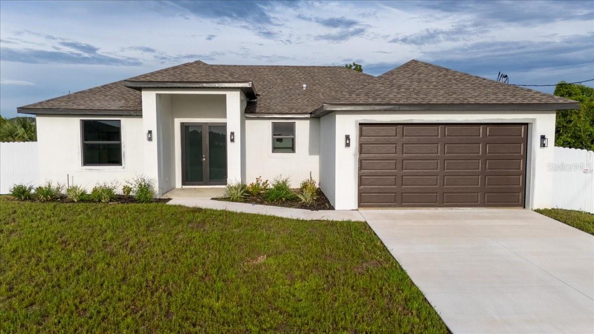 Gorgeous new construction home with pool in desirable NW Cape Coral! This modern residence offers open-concept living, high ceilings, and elegant finishes throughout. Enjoy a beautiful kitchen with quartz countertops, spacious bedrooms, and a stunning screened-in pool area perfect for entertaining or relaxing. Located in a quiet neighborhood close to Burnt Store Rd, parks, and shopping — your Florida dream home is ready!