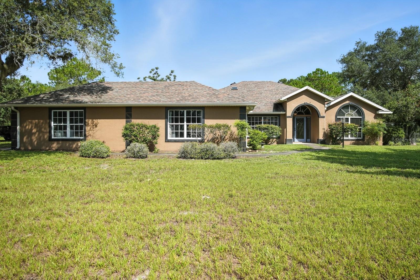Don't miss your opportunity on this turn-key, 15-acre estate is high and dry with no flooding concerns. This home is ready for you and your animals to move right in. Nestled at the end of a private road, this beautifully maintained home offers 3 bedrooms, 2.5 bathrooms, and a spacious open floor plan with a split-bedroom design, perfect for both entertaining and everyday privacy.
The kitchen is designed for function and style, featuring ample cabinet and counter space, plus two separate pantries for extra storage.
The primary suite is a true retreat with dual walk-in closets, double vanities, and a relaxing garden tub.
Outside, the entire property is fully fenced, with lush pastures equipped with automatic waterers.
The barn includes three stalls, a center aisle, tack room, feed room, and a small workshop. Just behind the barn, an enclosed shop offers ideal space for storage or projects.
Additional features include a well house, a shed near the front of the property, a koi pond, and a game room that could easily be converted into a fourth bedroom. Roof is less than 5 years old!