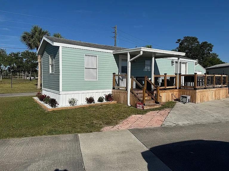 Bring your toothbrush and clothes! Snowbirds and 55+ buyers—discover effortless Florida living! This fully furnished, totally remodeled 1 bed/1 bath park model single-wide looks like new inside and is truly turnkey. Located in an active gated, lakefront 55+ community where you OWN your lot, you're near I-95, a short drive to the beaches, and convenient to OIA. Beautifully furnished bright, open interior with updated kitchen and bath, quality flooring, and fresh finishes throughout. Sitting on a desirable corner lot with 3 parking spaces, it also boasts a large front wood deck—perfect for morning coffee and possible storage underneath. A utility shed adds handy storage for beach gear and tools. Low-maintenance living, with lower HOA fee means more time for fun—relax, socialize, and lock-and-leave with confidence. Bring your suitcase and start your best season now!