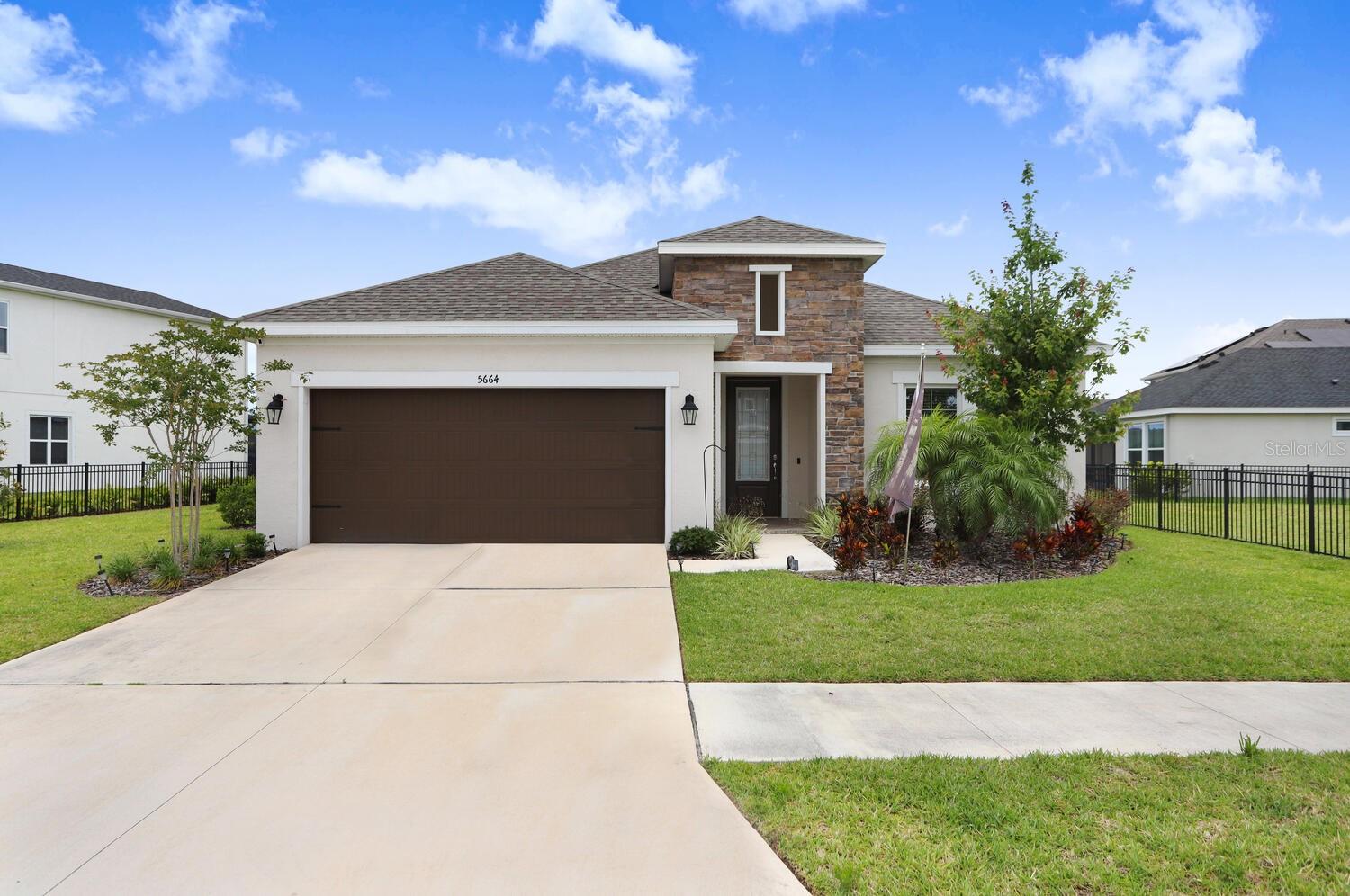 Welcome to this stunning 2 year old waterfront home in the desirable Waterset community. This beautiful home offers 4 bedrooms, 3 full baths, a designated office, and a large bonus room, making it perfect for families of all sizes or even multi generational families. As you enter, you will be impressed by the spacious feeling created by 10 to 12 ft high ceilings. The Master Bathroom and Bonus Room have 8 ft. frosted glass barn doors that add to the elegance. Main living areas have ceramic plank flooring, while bedrooms have carpet. The kitchen has beautiful cabinetry, granite counters, gas stove, walk in pantry, all stainless steel appliances and a beautiful tile backsplash. The Master Bathroom contains a walk in tiled shower, separate toilet room, dual vanities and garden tub. The walk in closet has custom built ins. The other 3 bedrooms are at the front of the home with 2 on one side and the 3rd on other side with a hallway bathroom, making it perfect for guests or Grandma/Grandpa full time. The screened lanai at the rear of the home off the living room has sliding doors and is wired for a future television and ceiling fan. There are already speakers in the ceiling for that relaxing music in the evening while enjoying the view of the lake. The 2 car garage features overhead storage racks which convey with the home. This home also includes several features that add to its charm and convenience, such as a tankless water heater, water purifier, water softener, and built in cabinets in Laundry with large sink. As a resident of this charming community you will be able to enjoy the amenities including Clubhouse, Pool, Tennis Courts, Playgrounds, etc. With the luxurious living space and upgraded/exceptional features of this home, it is the perfect place to call home.