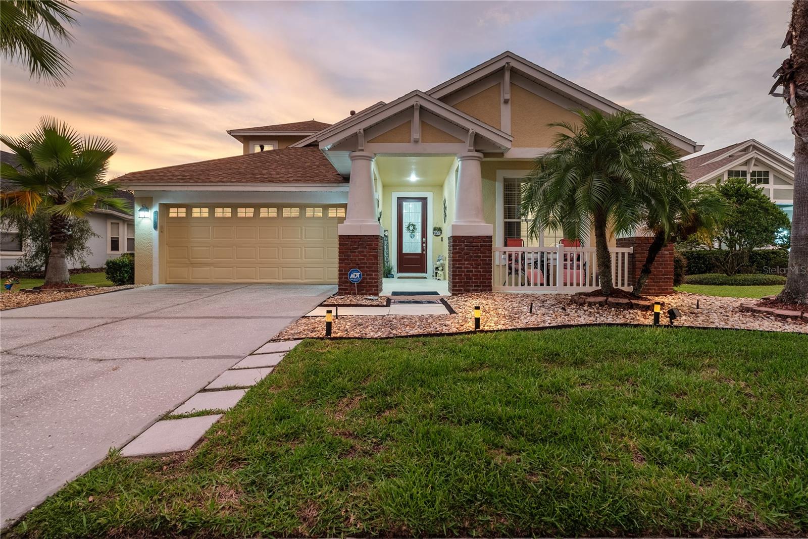 Welcome to the dream of Florida living in the guard-gated, resort-style community of Grand Hampton in New Tampa. This recently upgraded 2,500 sq ft. 3-bedroom, 2-bath pool home sits on a quiet cul-de-sac with tranquil water views. The eat-in kitchen features a breakfast nook, granite countertops, tile backsplash, and 2022 appliances. Enjoy marble flooring throughout, laminate in all bedrooms (no carpet), and a spacious upstairs loft perfect for an office, media room, or potential guest suite. The large master suite is split from the secondary bedrooms and includes a walk-in shower, soaking tub, dual vanities, and a walk-in closet. Triple-slider glass doors open to a screened pool area with stunning views of the water. Additional features include a 2-car garage with shelving, an extended driveway (capable of accommodating 2–4 cars), new landscaping, and a sectional sprinkler system. Major upgrades: new electric pool heater & pump (2025), roof (2024), HVAC (2023), appliances (2022), and water heater (2020). HOA includes full lawn care, 1-gig internet, and exterior painting every 5 years (next in 2027). Community amenities include 2 pools (resort-style with waterslide + Olympic lap pool), tennis & pickleball courts, fitness center, clubhouse, playgrounds, and walking trails. Move-in ready and a must-see!