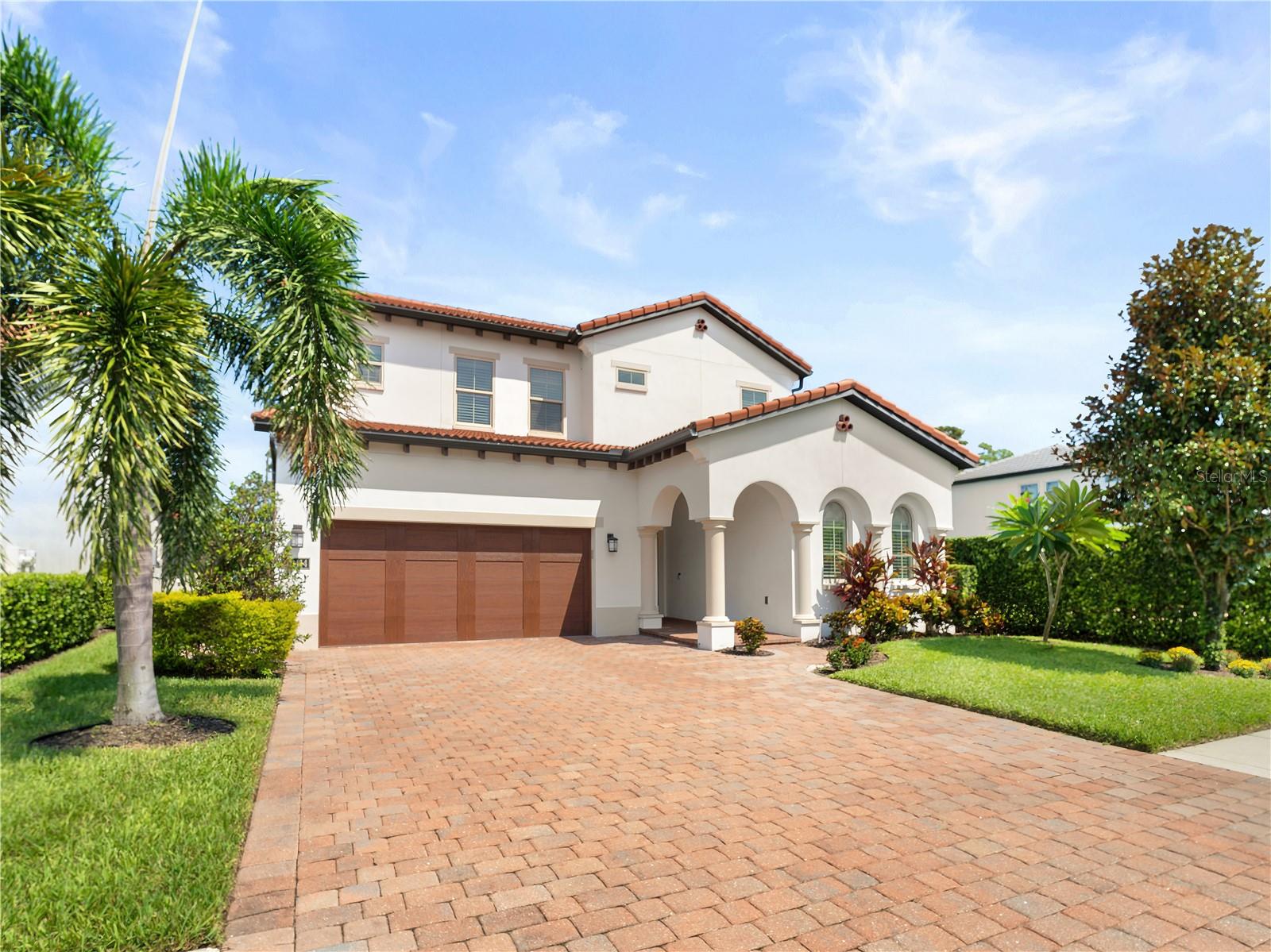 One or more photo(s) has been virtually staged. Situated in the exclusive, guard-gated Royal Cypress Preserve and built in 2018 by the award-winning Toll Brothers, this stunning two-story home features five bedrooms and 4.5 bathrooms, with several hundred thousand dollars in upgrades and new renovations. The property is on an oversized lot that backs to conservation land, ensuring exceptional privacy.
Blending timeless elegance with a modern open layout, the residence showcases high-end flooring, a stunning wrought iron and wood staircase, a bay-window dining area, a beautiful fireplace in the family room, and custom window treatments throughout. Recent updates include a complete interior repaint, new quartz countertops, upgraded kitchen cabinetry, custom kitchen island with a waterfall quartz countertop, designer lighting fixtures, new glass shower enclosures, and refreshed finishes for a like-new feel. The gourmet kitchen is equipped with stainless steel appliances, a new farmhouse-style stainless steel sink, and a butler’s pantry. Spacious living and dining areas are ideal for entertaining, while the upstairs loft serves as a versatile retreat. The primary suite features a private balcony overlooking conservation land for maximum privacy, a large walk-in closet, and a spa-inspired bathroom with an upgraded cast iron freestanding tub, premium tiles, dual vanities, and a glass-enclosed shower. Additional bedrooms provide ample space, including a main-level guest suite with a full bath.
Outdoor living spaces include an oversized paver driveway, a large marble backyard lanai with views of Disney fireworks, an oversized upstairs balcony, and a privacy wall with all hookups ready for your custom summer kitchen.
Residents enjoy resort-style amenities such as a clubhouse, zero-entry pool, fitness center, playground, dog park, and a private boat launch onto the scenic 124-acre South Lake. The community is conveniently located and zoned for top-rated Windermere public schools and minutes to Windermere Prep. It’s just minutes from Orlando’s luxury resorts, fine dining, major highways, and world-class theme parks!
