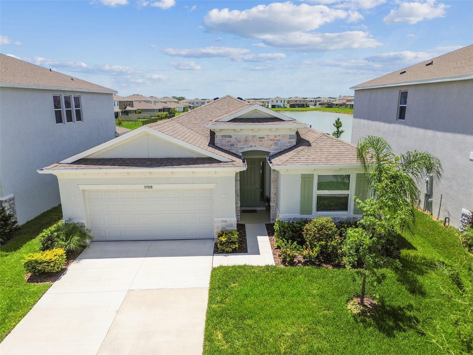 Better than a new build and ready now! This stunning, ONE YEAR YOUNG home is located in the
highly sought-after community of AVALON PARK IN WESLEY CHAPEL. Impeccably maintained and
thoughtfully upgraded, this home features 4 spacious bedrooms, 2.5 bathrooms, and a 2-car
garage, offering both style and functionality. This home is ENERGY EFFICIENT for LOW AND
AFFORDABLE UTILITY BILLS!
The open-concept layout is enhanced with upgraded tile flooring throughout, CUSTOM SLIDER
BLINDS, high elevated ceilings for that luxury look, tall baseboards, and fresh, neutral interior
paint, creating a bright feel throughout. Don’t forget about the BRAND NEW GUTTERS and
INCLUDED WASHER AND DRYER! The primary suite is a peaceful retreat, complete with dual walk-
in closets, QUARTZ countertops, a walk-in shower, soaking tub, and double vanities. The split floor
plan offers privacy with spacious secondary bedrooms and an ideal setup for guests.
The heart of the home is the MASSIVE KITCHEN, which INCLUDES ALL stainless steel appliances,
QUARTZ countertops, decorative glass tile backsplash, upgraded cabinetry, a LARGE CENTER
ISLAND, and a counter height seating. The kitchen flows seamlessly into the main living area, where
SLIDING GLASS DOORS open to a COVERED PATIO creating a seamless indoor-outdoor
connection.
Step outside for the STUNNING POND VIEW that sets this home apart! With NO REAR
NEIGHBORS, the backyard becomes a private oasis where peaceful water views and
BREATHTAKING SUNSETS can be enjoyed everyday. Whether relaxing after a long day or hosting
evening gatherings, this setting offers the perfect backdrop for quiet moments and memorable
experiences.
Located in a quiet neighborhood with sidewalk lined streets, the community features LOW HOA
fees, a community pool, splash pad, playground, and open green space for outdoor fun. Avalon
Park hosts REGULAR COMMUNITY EVENTS such as FOOD TRUCK nights, HOLIDAY EVENTS and
FUN, FIREWORKS, and more!
All of this is nestled in the ever-growing Avalon Park area, where exciting additions are on the
horizon, including a town center with shops and dining, medical facilities, and community events.
The designed village that has been created is a true LIVE-WORK-PLAY LIFESTYLE in one of Wesley
Chapel’s most vibrant communities.
This PRIME LOCATION also provides easy access to I-75 and I-275, providing quick access to downtown
Tampa. Just minutes from Wiregrass Mall, The Grove, KRATE at the Grove, Tampa Premium Outlets,
Cooper’s Hawk Winery & Restaurant, top HEALTHCARE FACILITIES, and RECREATIONAL SPOTS, this
LOCATION offers a balanced lifestyle with EVERYTHING you need nearby.