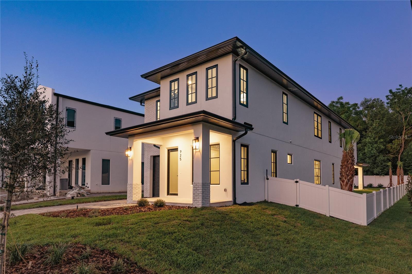 Extraordinary new construction estate by LUIH Luxury Homes, where architectural brilliance meets lakeside serenity in the heart of SoDo. Perfectly positioned on a premier corner lot with stunning views of Lake Emerald, this one-of-a-kind residence is just minutes from Downtown Orlando. Step into an open, light-filled interior, where soaring ceilings, expansive windows showcasing irresistible lake views, and bespoke designer finishes create a sense of luxury. At the heart of the home, the chef’s kitchen is a culinary dream, featuring waterfall-edge quartz countertops, custom soft-close cabinetry, professional-grade Thermador appliances, and an artfully designed wet bar with wine refrigeration, floating shelving, and subtle LED underlighting. The primary suite is a true retreat, perfectly positioned to capture peaceful lake views. Inside you will find dual boutique-style his & hers walk-in closets, a spa-inspired bathroom with a freestanding soaking tub, expansive glass-enclosed shower, and dual vanities. Each secondary bedroom is generously sized, offering oversized closets providing both comfort and exceptional storage. Additional upgrades include a dedicated home office, a spacious walk-in pantry, and a covered front porch for enjoying amazing lake views. The backyard is an entertainer’s paradise featuring a sparkling pool, a covered lanai, and a fully equipped summer kitchen. Located just minutes from all of Downtown Orlando’s entertainment and dining options and just steps from the renowned Lancaster & Davis parks, you are truly in the heart of everything this charming neighborhood has to offer. Gracefully poised along the shimmering shores of Lake Emerald and adorned with uncompromising finishes, this home epitomizes the height of Orlando’s luxury living.
