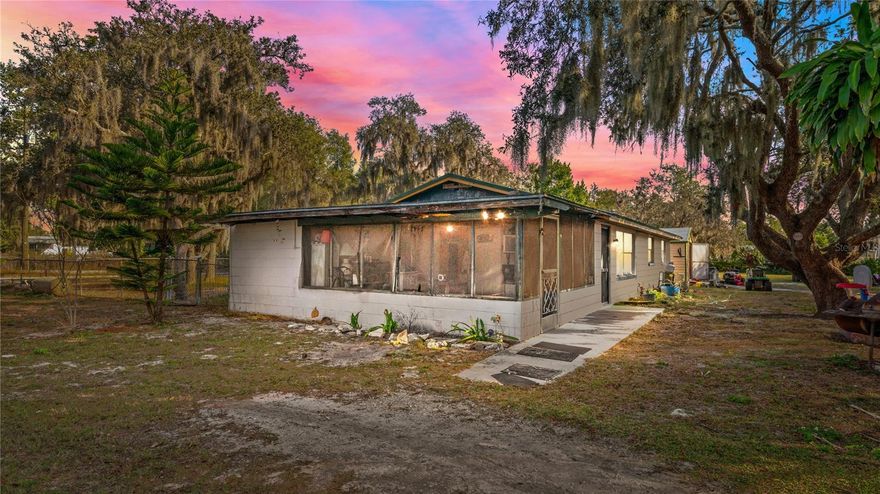 Situated on approximately 2.2 fully fenced acres, this unique property offers space, flexibility, and opportunity in a highly desirable and convenient location surrounded by newer homes. Priced to sell, it presents an excellent option for owner-occupants, investors, or those seeking land with future potential.The main residence, positioned toward the rear of the property, is a block-constructed 3-bedroom, 1-bath home featuring a functional layout with the kitchen opening to the dining area and living space, plus a screened front porch ideal for enjoying the peaceful setting. A brand-new metal roof adds long-term value and peace of mind.Mature oak trees, expansive open space, and full fencing enhance both privacy and usability, offering endless possibilities for outdoor living, storage, or future improvements.With its generous acreage, multiple dwellings, and favorable location, experienced buyers may wish to explore zoning and development opportunities. Properties of this size and versatility are increasingly rare in the area, making this a compelling opportunity for those looking to secure land, income, and long-term upside.Don’t miss the chance to own over two acres in a rapidly growing area—schedule your private showing today.