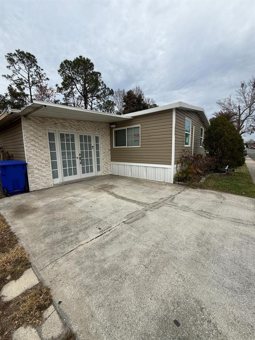 Convenience meets comfort in this beautifully updated 3-bedroom, 2-bath manufactured home located near UCF with quick access to major highways and everyday shopping. This home has been thoughtfully remodeled and is truly move-in ready.

Step inside to enjoy a brand-new kitchen with new appliances, refreshed finishes, and a bright, modern feel. The primary suite features an exceptionally large walk-in closet, offering the space and storage you’ve been looking for. For added peace of mind, the home includes double-pane impact windows.

One of the standout features is the enclosed garage, creating a flexible bonus area—perfect for a game room, second living space, home office, entry lounge, or whatever fits your lifestyle. You’ll also appreciate the 10x12 storage building, fully enclosed and fully permitted, with permits current and up to date.

Additional upgrades include a mini-split inverter system and a propane gas stove. The propane provider services it monthly, with an approximate monthly cost of $15.

Important: This manufactured home is located in a community with a monthly land lease / lot rent (buyer to verify exact amount with the community). Schedule your private showing today!