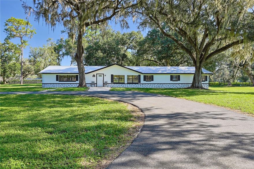 Welcome to Belleview, Florida, and to your dream ten-acre farm. This beautifully-renovated three-bedroom, two-bath home, sits on
ten fenced acres with seventeen horse-stalls, and is ideal for an equestrian lifestyle. The property blends the beauty of country-living with modern updates and is ready for you to call home. From the moment you arrive, the circular driveway and stunning
oak trees set the stage. It’s peaceful, shaded, and offers the kind of Florida-charm everyone desires. Step inside and you’ll be captivated by the open floor plan that is spacious and designed for both everyday living and formal entertaining. The kitchen is the heart of the home featuring durable luxury vinyl flooring underfoot, with sleek stone countertops, and an abundance of cabinet space. Whether you’re cooking for the family or hosting friends, this space is both functional and stylish. The flow from the kitchen into the dining and living areas, makes gatherings effortless. The generously-sized primary is accompanied by well- appointed bathroom. Now, let’s step outside again to review the enormous 10-acre farm with horse stalls and segmented pastures. The land is beautiful and versatile. Whether your vision includes pastures, gardens, or wide-open riding space, you’ve got the acreage to make it happen. Equestrians will find this property, with seventeen stalls, perfect for competitive riders, training, boarding, or housing your own horses. This Belleview home isn’t just a farm - it’s a lifestyle. Ten acres, seventeen stalls, fruit trees, and stunning oak canopies are all waiting for you. Just minutes from Publix, restaurants, and downtown Belleview, this gorgeous land is perfect for horse lovers, hobby farmers, or anyone seeking a quiet retreat with convenience access to town. The property is move-in ready with plenty of room to grow. Don’t miss this rare opportunity to own a farm in a prime location! Ready to see for yourself? Call today for your private tour!