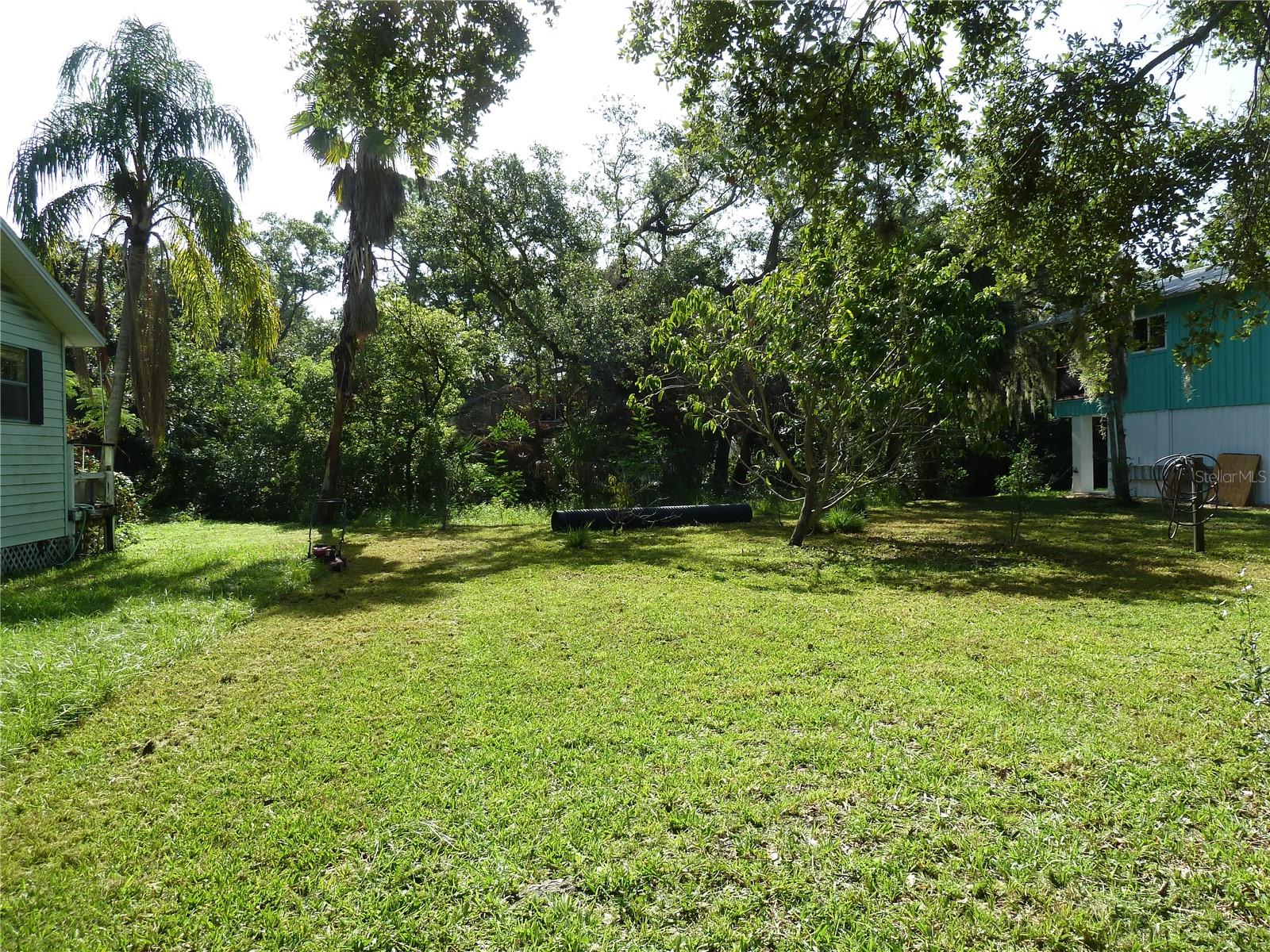 Discover a rare opportunity to own a slice of Old Florida nestled just off Hillsborough Avenue and Race Track Road—on the Tampa side, just across the Pinellas County line. This 60x130 ft vacant lot offers the perfect canvas for your custom-built dream home, free from HOA restrictions or architectural overlays. Let your creativity shine while following standard county guidelines—no cookie-cutter homes here.
Backing up to a peaceful canal with direct access to Mobbly Bay and Old Tampa Bay, this property provides the ideal setting for kayaking, paddleboarding, or simply enjoying a tranquil water view from your own backyard. The surrounding neighborhood is refreshingly eclectic, with no two homes alike—each property reflecting its owner’s unique style and vision.
Tucked away on a quiet country road yet just minutes from the conveniences of city life, you'll enjoy the best of both worlds. Nearby attractions include the beloved HorsePower for Kids farm, as well as easy access to shops, dining, and major thoroughfares.
Whether you're a builder, an investor, or a homeowner dreaming of something truly different, this property offers location, flexibility, and character—an increasingly rare combination in today’s market. Come see it today!