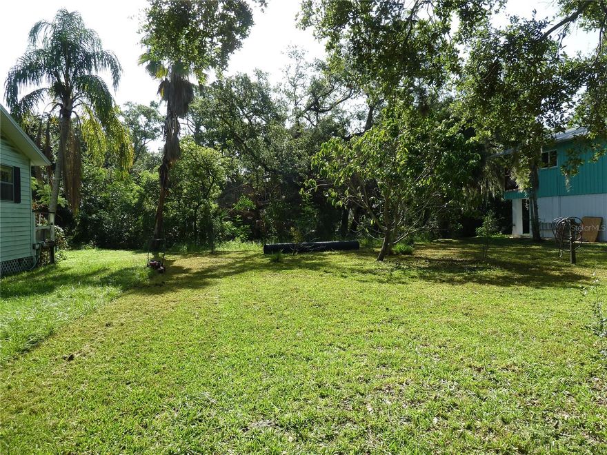 Discover a rare opportunity to own a slice of Old Florida nestled just off Hillsborough Avenue and Race Track Road—on the Tampa side, just across the Pinellas County line. This 60x130 ft vacant lot offers the perfect canvas for your custom-built dream home, free from HOA restrictions or architectural overlays. Let your creativity shine while following standard county guidelines—no cookie-cutter homes here.

Backing up to a peaceful canal with direct access to Mobbly Bay and Old Tampa Bay, this property provides the ideal setting for kayaking, paddleboarding, or simply enjoying a tranquil water view from your own backyard. The surrounding neighborhood is refreshingly eclectic, with no two homes alike—each property reflecting its owner’s unique style and vision.

Tucked away on a quiet country road yet just minutes from the conveniences of city life, you'll enjoy the best of both worlds. Nearby attractions include the beloved HorsePower for Kids farm, as well as easy access to shops, dining, and major thoroughfares.

Whether you're a builder, an investor, or a homeowner dreaming of something truly different, this property offers location, flexibility, and character—an increasingly rare combination in today’s market. Come see it today!

Please note: Vacant land rarely has an address or lot number posted. There have been occasions when a buyer has closed on a property and determined, after the closing, that the property conveyed to the buyer was not the property the buyer had visually identified prior to signing the contract.  It is the buyer’s responsibility to confirm the legal description of the property the buyer wants to purchase prior to the end of the contract Property Inspection Period. The best way to accomplish this is for the buyer to obtain a survey that depicts a physical immovable object on the property or adjacent to the property that irrefutably confirms the property identified in the survey is the property the buyer wants to purchase.